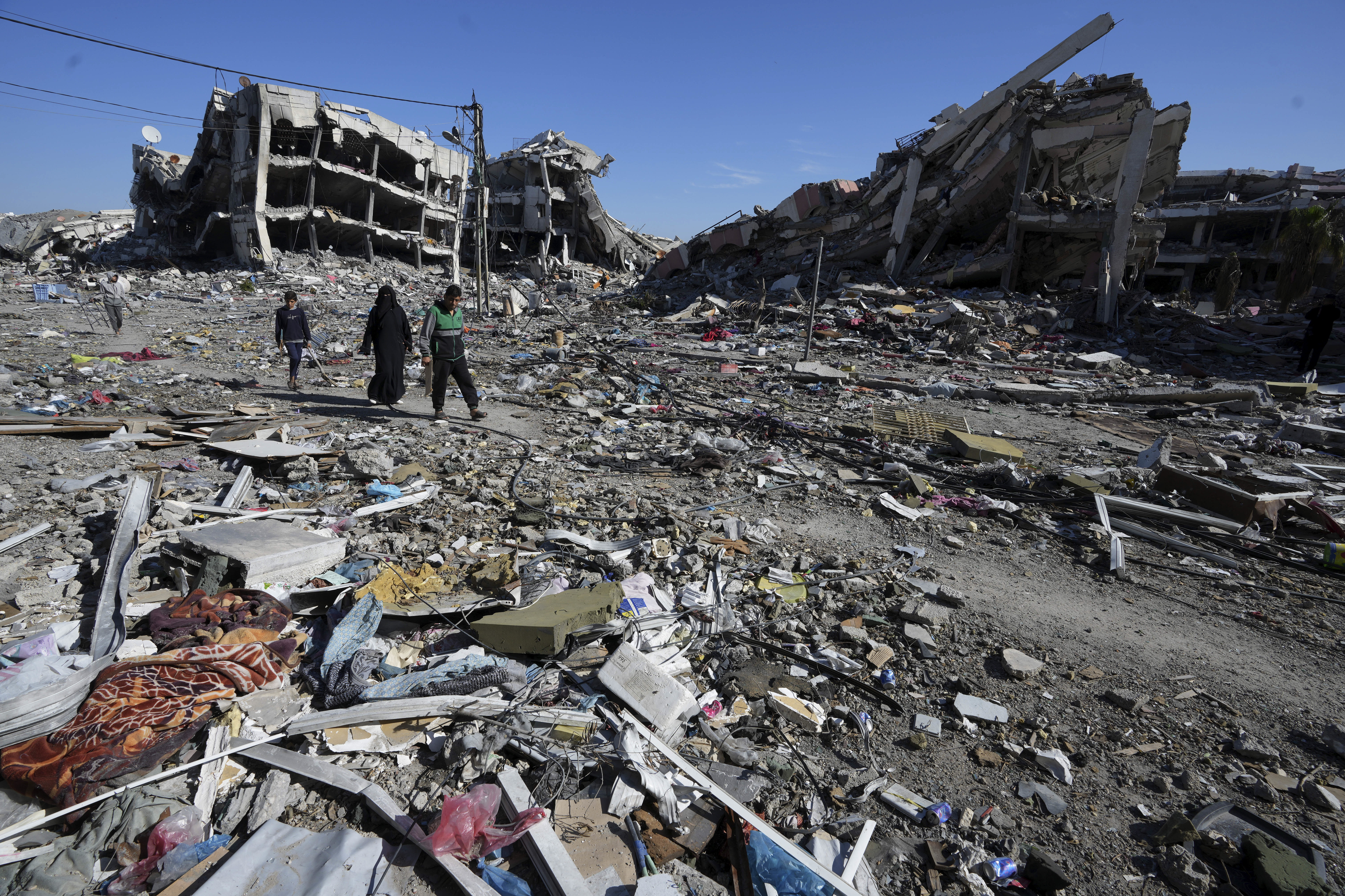Palestinians visit their houses destroyed in the Israeli bombings in Al-Zahra, on the outskirts of Gaza City, on Thursday, Nov. 30, 2023. during the temporary ceasefire between Hamas and Israel. (AP Photo/Adel Hana)