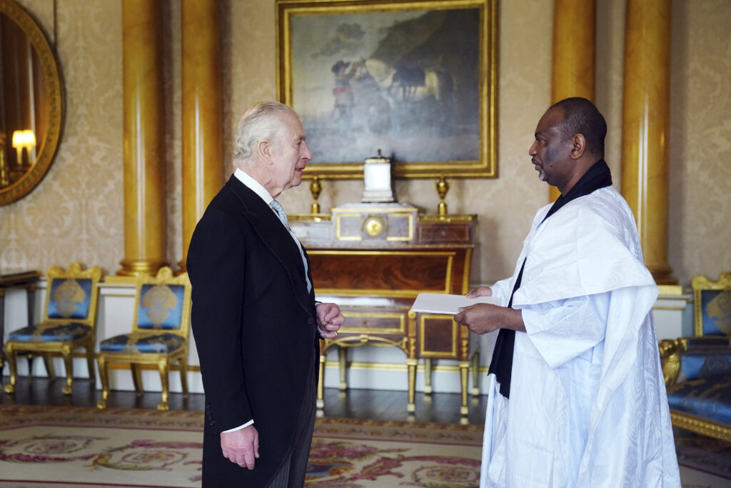 The Ambassador of Mauritania Samba Mamadou, right, presents his credentials to Britain's King Charles III during a private audience at Buckingham Palace, London, Wednesday March 6, 2024. (Victoria Jones/Pool via AP)