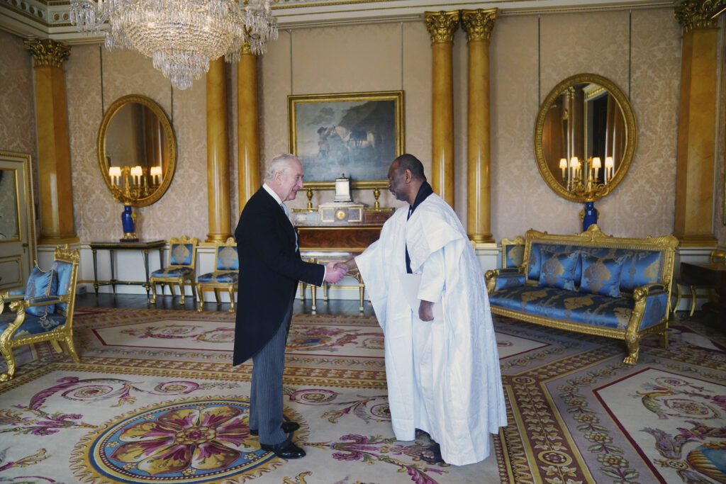The Ambassador of Mauritania Samba Mamadou, right, presents his credentials to Britain's King Charles III during a private audience at Buckingham Palace, London, Wednesday March 6, 2024. (Victoria Jones/Pool via AP)