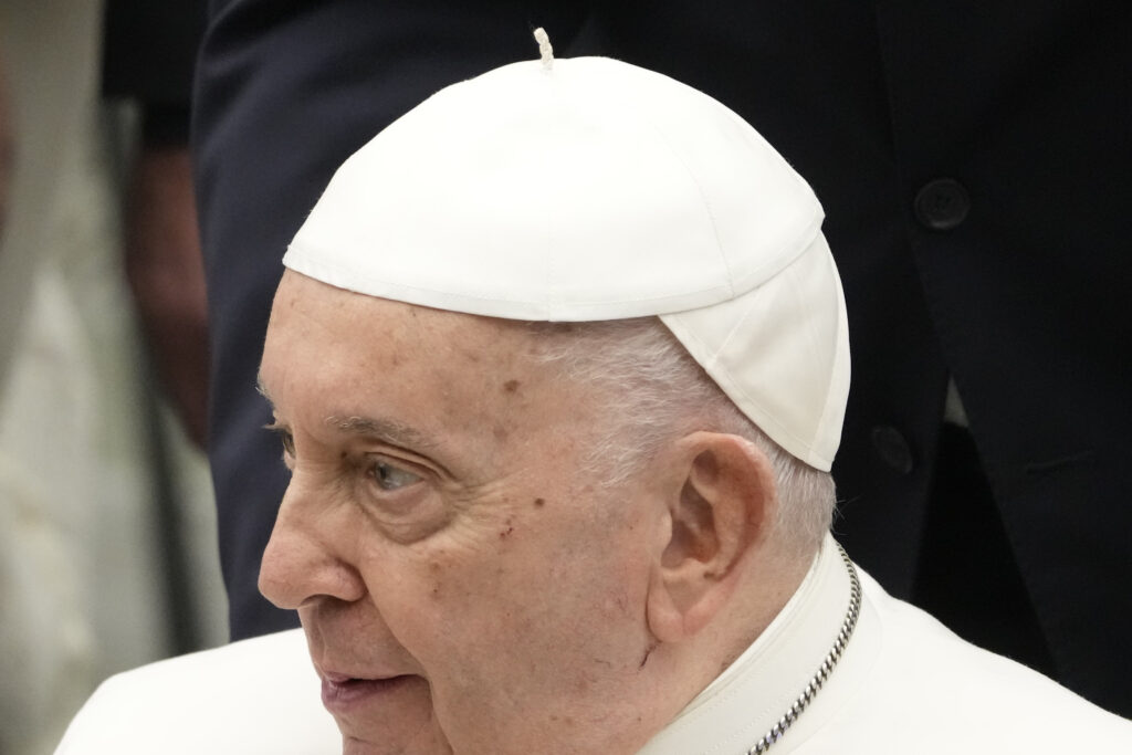 Pope Francis wears a skullcap donated by faithful during the weekly general audience at the Vatican, Wednesday, Nov. 29, 2023. (AP Photo/Gregorio Borgia)