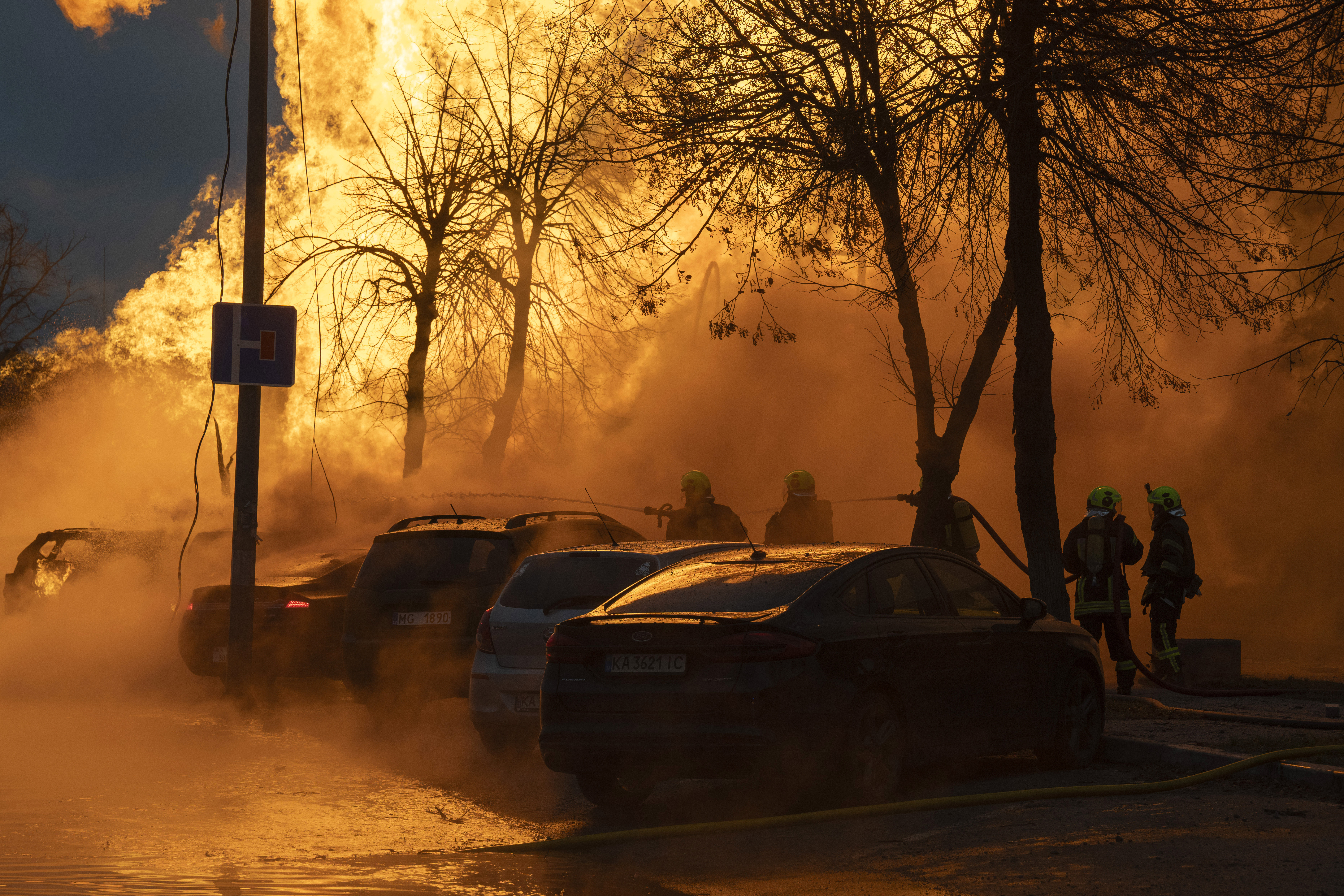 Firefighters work to extinguish a fire after a Russian attack in Kyiv, Ukraine, Tuesday, Jan. 2, 2024. (AP Photo/Efrem Lukatsky)