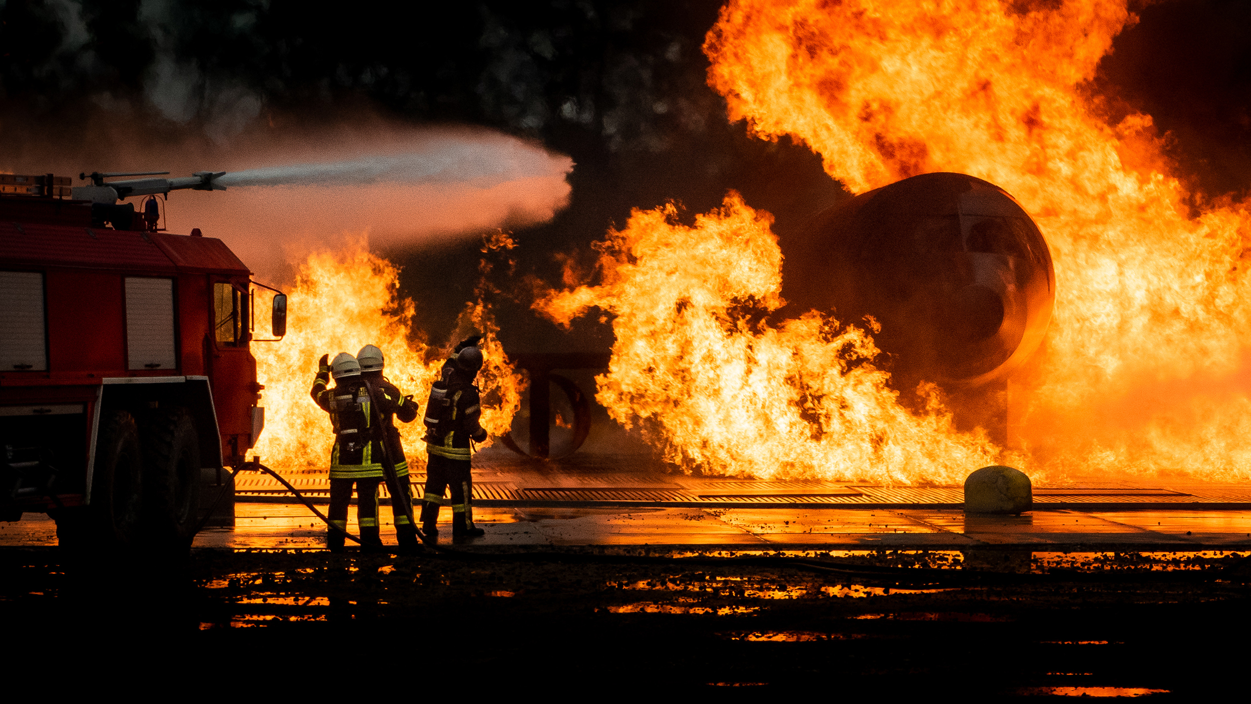 Fire fighting team fights valiantly to extinguish an inferno in an plane crash exercise