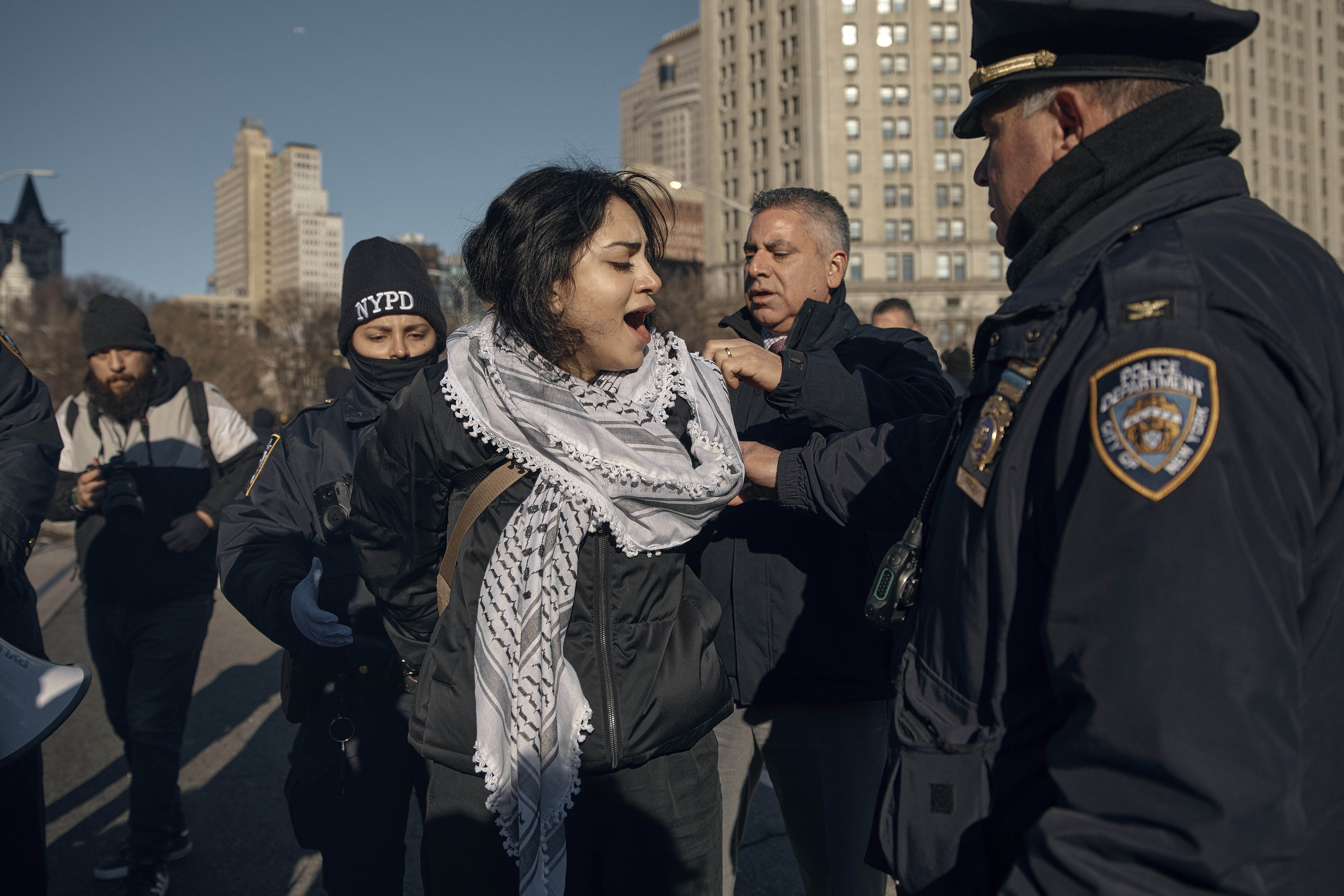 Police make arrests as protesters block Brooklyn Bridge during a pro-Palestinian demonstration demanding the cease-fire on the Israel-Palestinian conflict on Monday, Jan. 8, 2024, in New York. (AP Photo/Andres Kudacki)