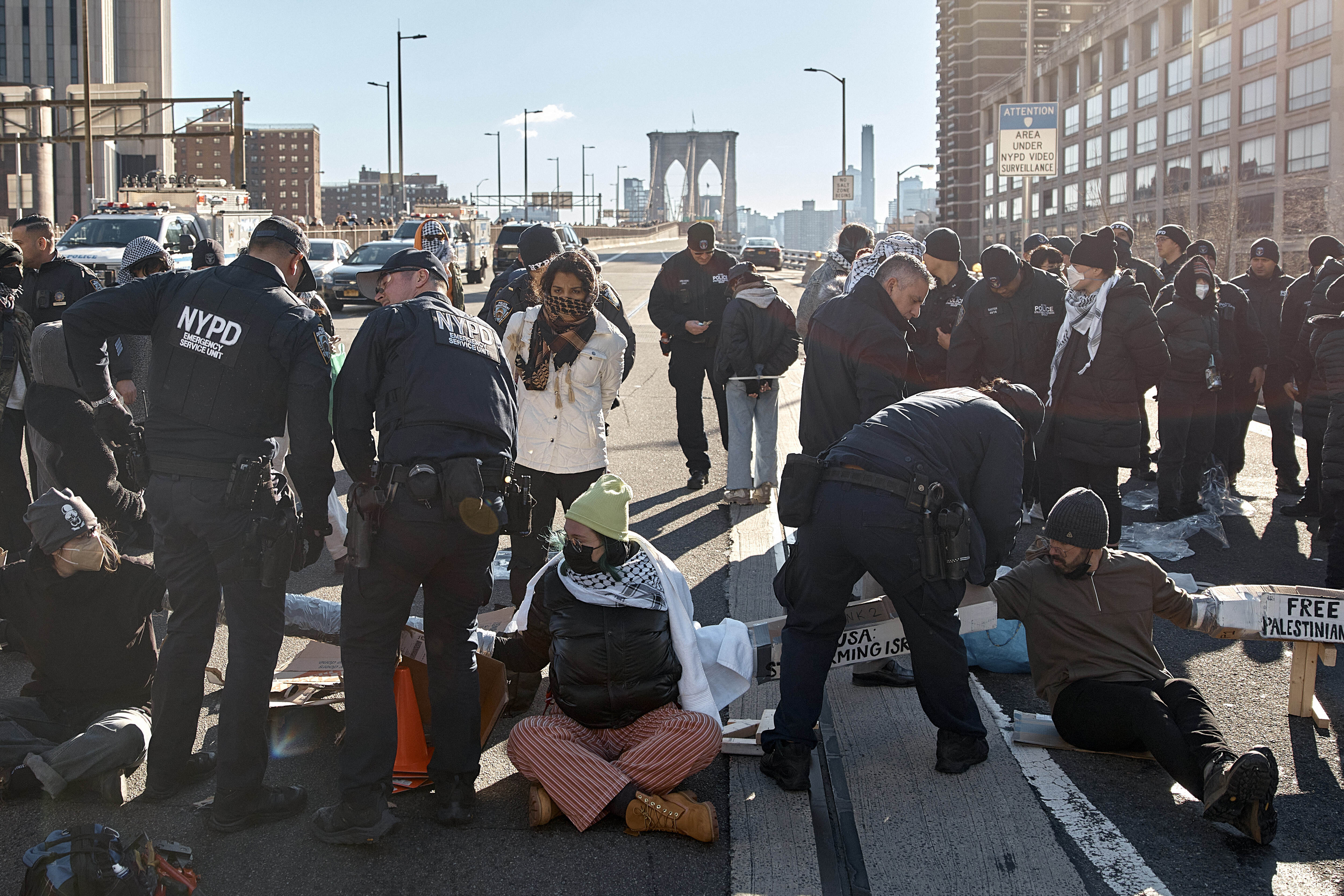 Police make arrests as protestors block Brooklyn Bridge during a pro-Palestinian demonstration demanding  a cease-fire in the Israel-Palestinian conflict on Monday, Jan. 8, 2024, in New York. (AP Photo/Andres Kudacki)