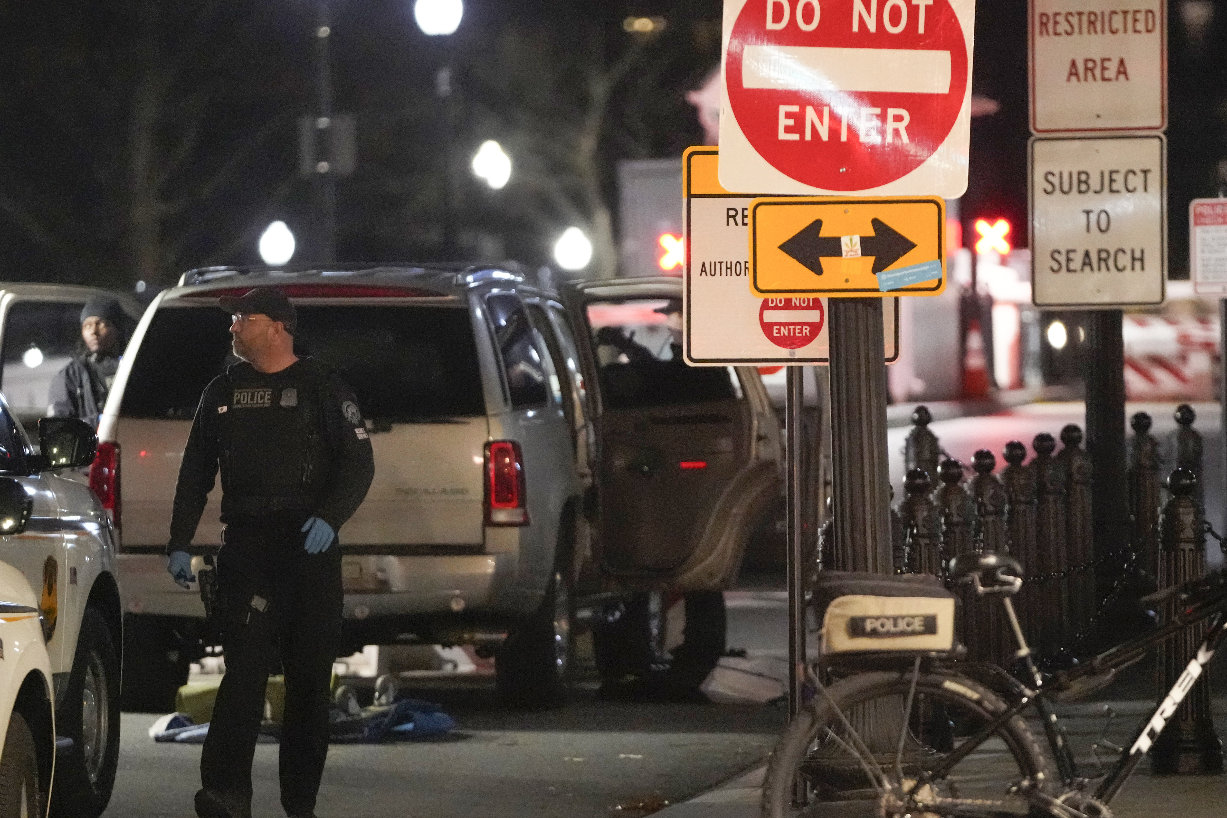 U.S. Secret Service police investigate near a vehicle that hit a security barrier at a entry point for the White House complex Monday, Jan. 8, 2024, in Washington. (AP Photo/Mark Schiefelbein)