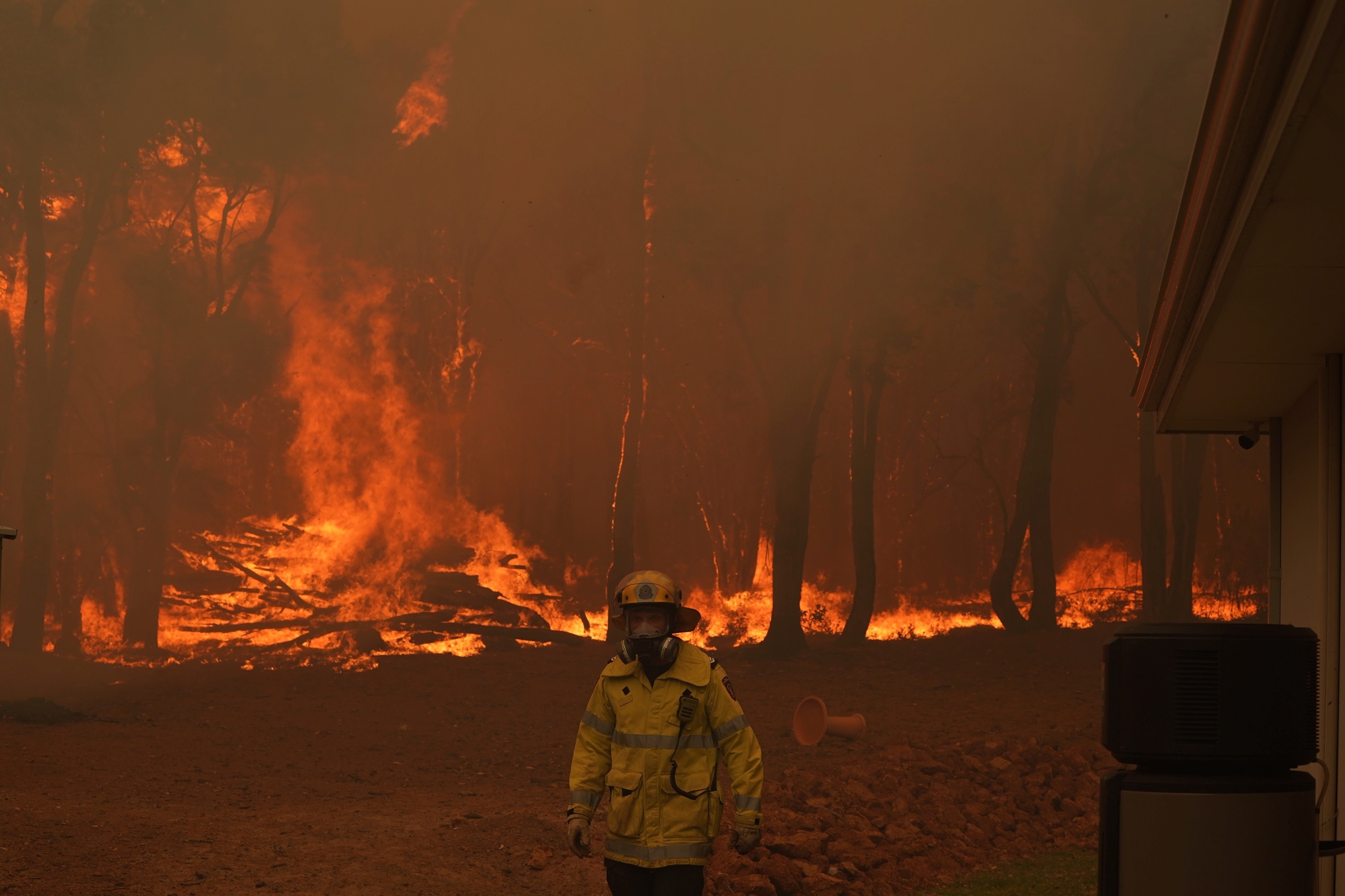 A Department Of Fire and Emergency Services fire fighter battles a bushfire in Brigadoon, Perth