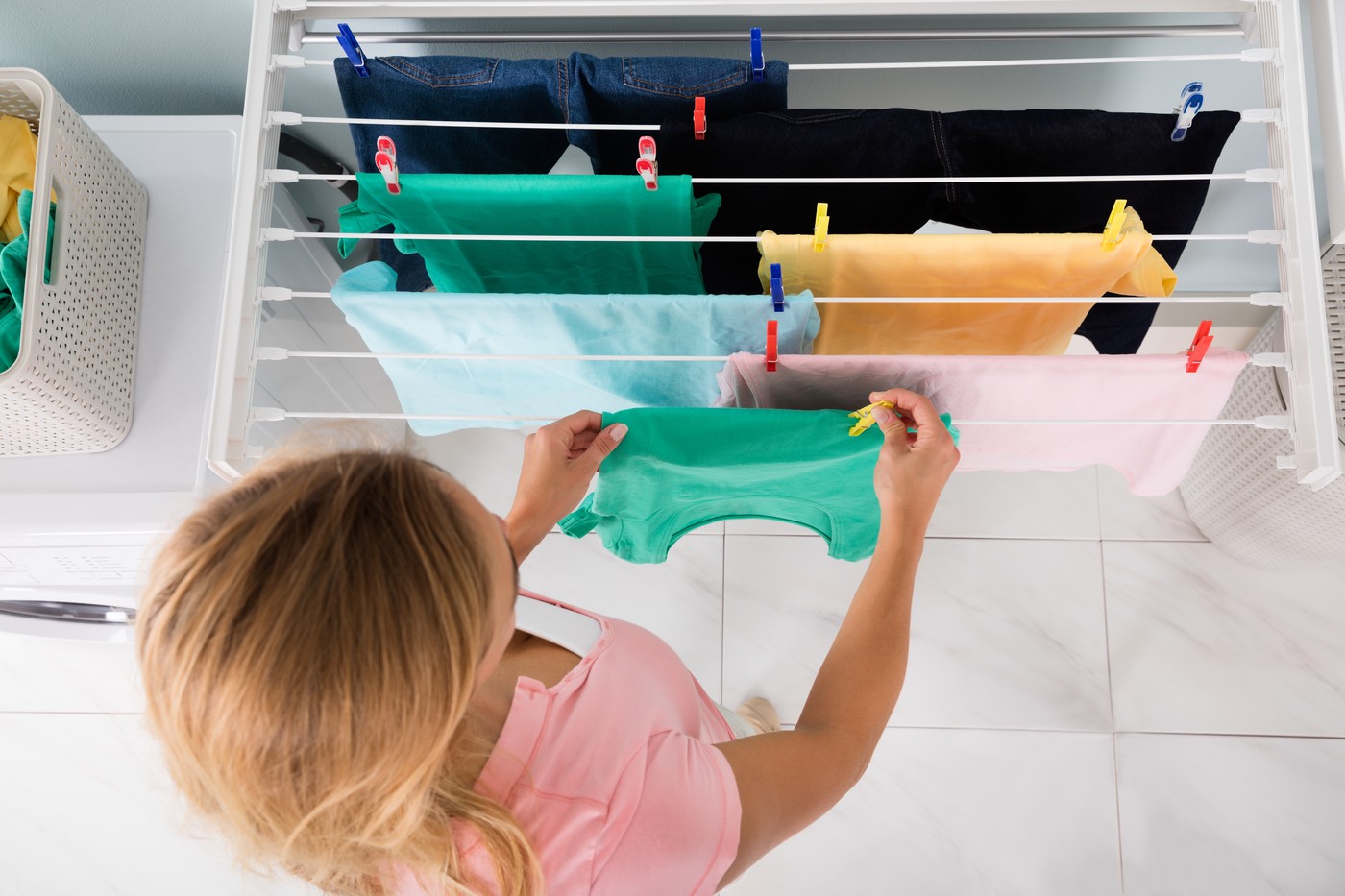 High Angle View Of Woman Hanging Wet Clean Cloth On Clothes Line At Laundry Room,Image: 335387164, License: Royalty-free, Restrictions: , Model Release: yes, Credit line: Andriy Popov / Panthermedia / Profimedia