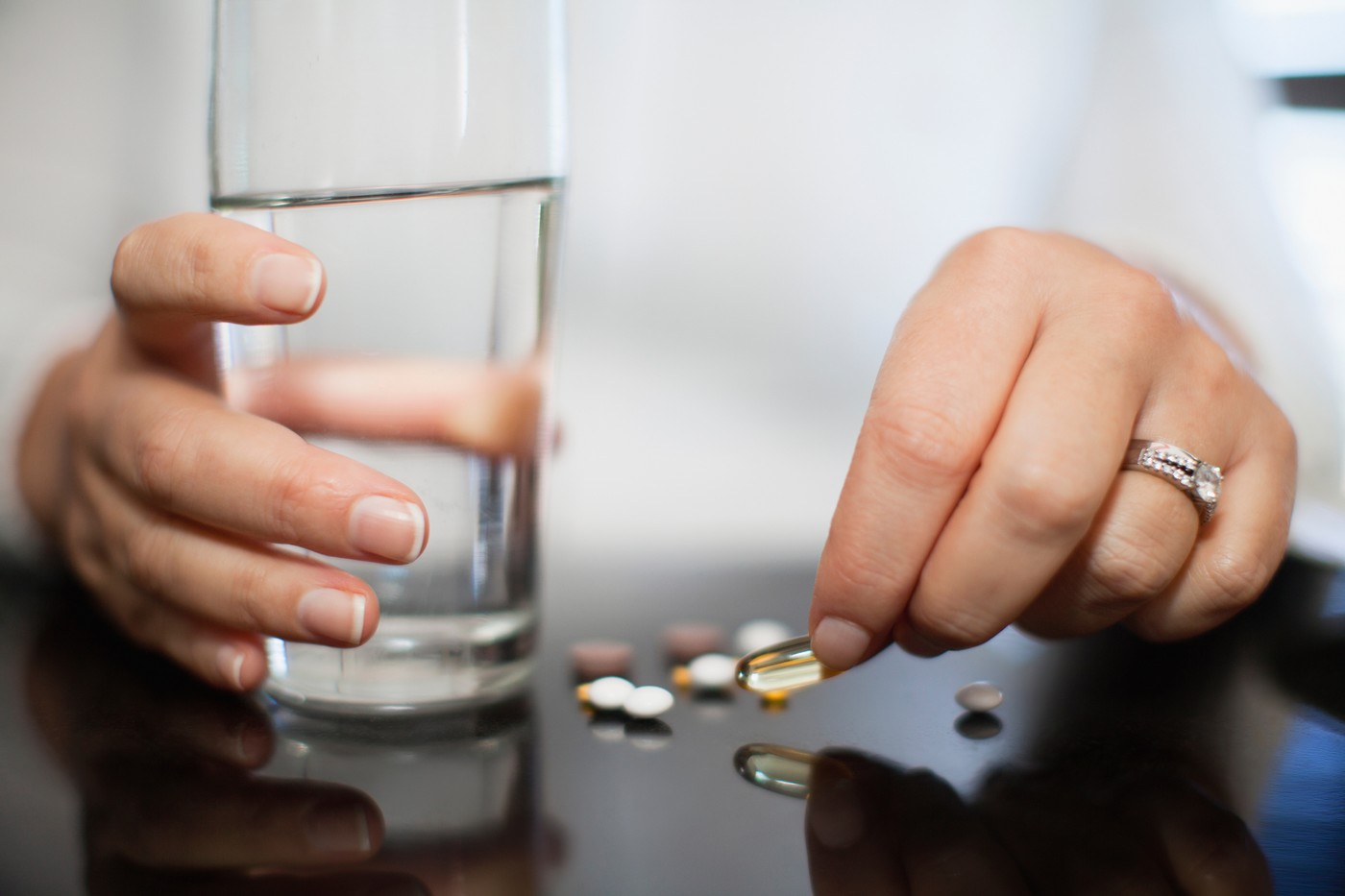 Close up of woman taking vitamins