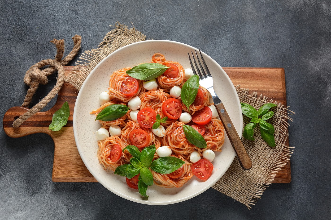 Italian Colorful Pasta dish or Spaghetti Napolitana with cherry tomatoes,   vegan mozzarella and basil,Image: 626516326, License: Royalty-free, Restrictions: , Model Release: no, Credit line: Natalie Hanin / Panthermedia / Profimedia