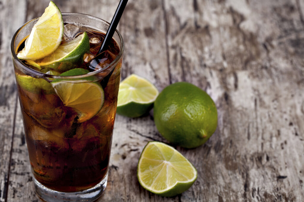 Cuba Libre Drink with lime on a wooden table,Image: 778355876, License: Royalty-free, Restrictions: , Model Release: no, Credit line: Serghei Platonov / imageBROKER / Profimedia