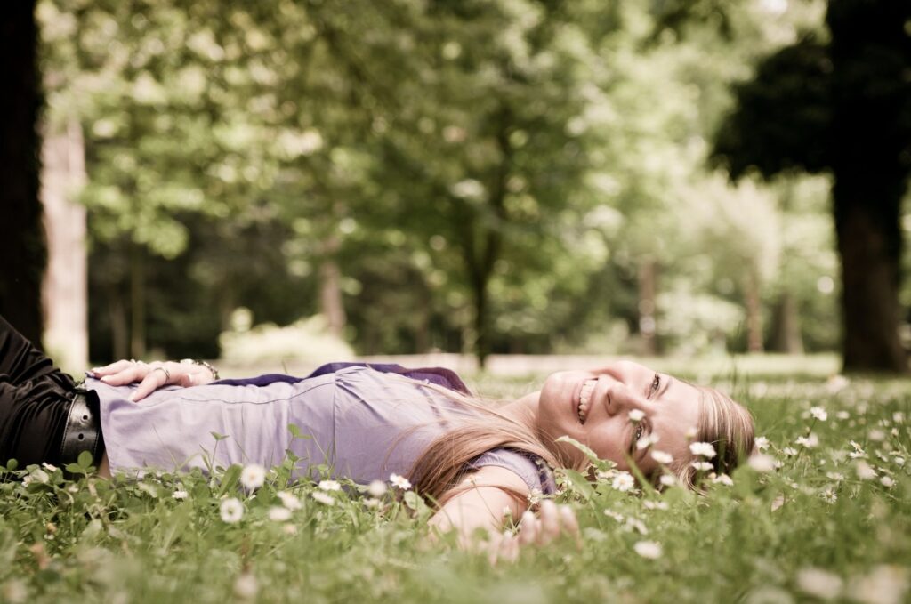 Detail of young woman lying in fresh green grass with flowers - low angle view,Image: 169230972, License: Royalty-free, Restrictions: , Model Release: yes, Credit line: Martin Novak / Panthermedia / Profimedia