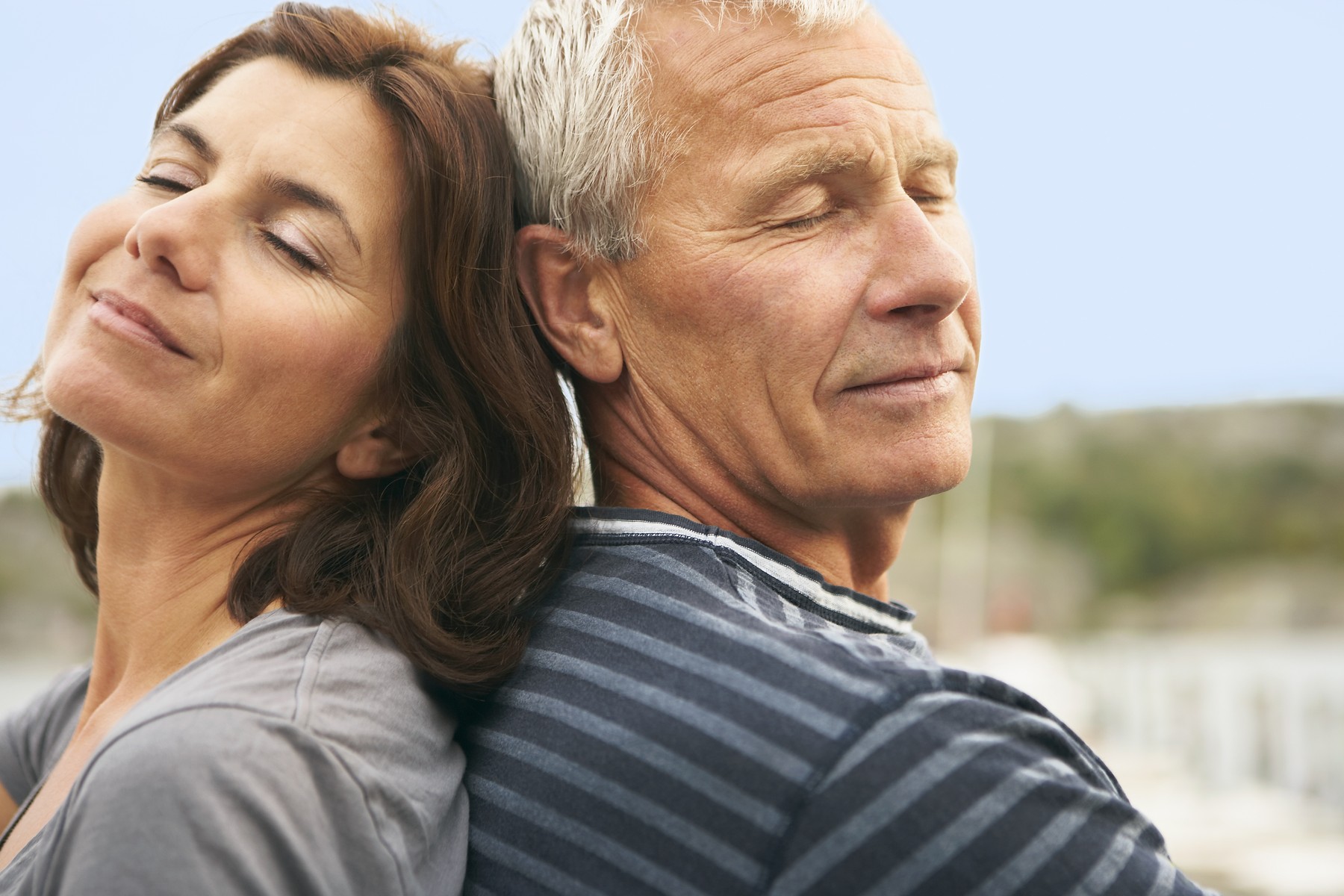 Middle aged couple, back to back