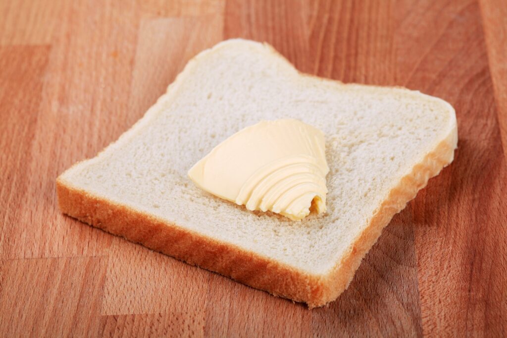 Slice of white bread and bit of butter,Image: 90024536, License: Rights-managed, Restrictions: , Model Release: no, Credit line: Afis / Digifoodstock / Profimedia