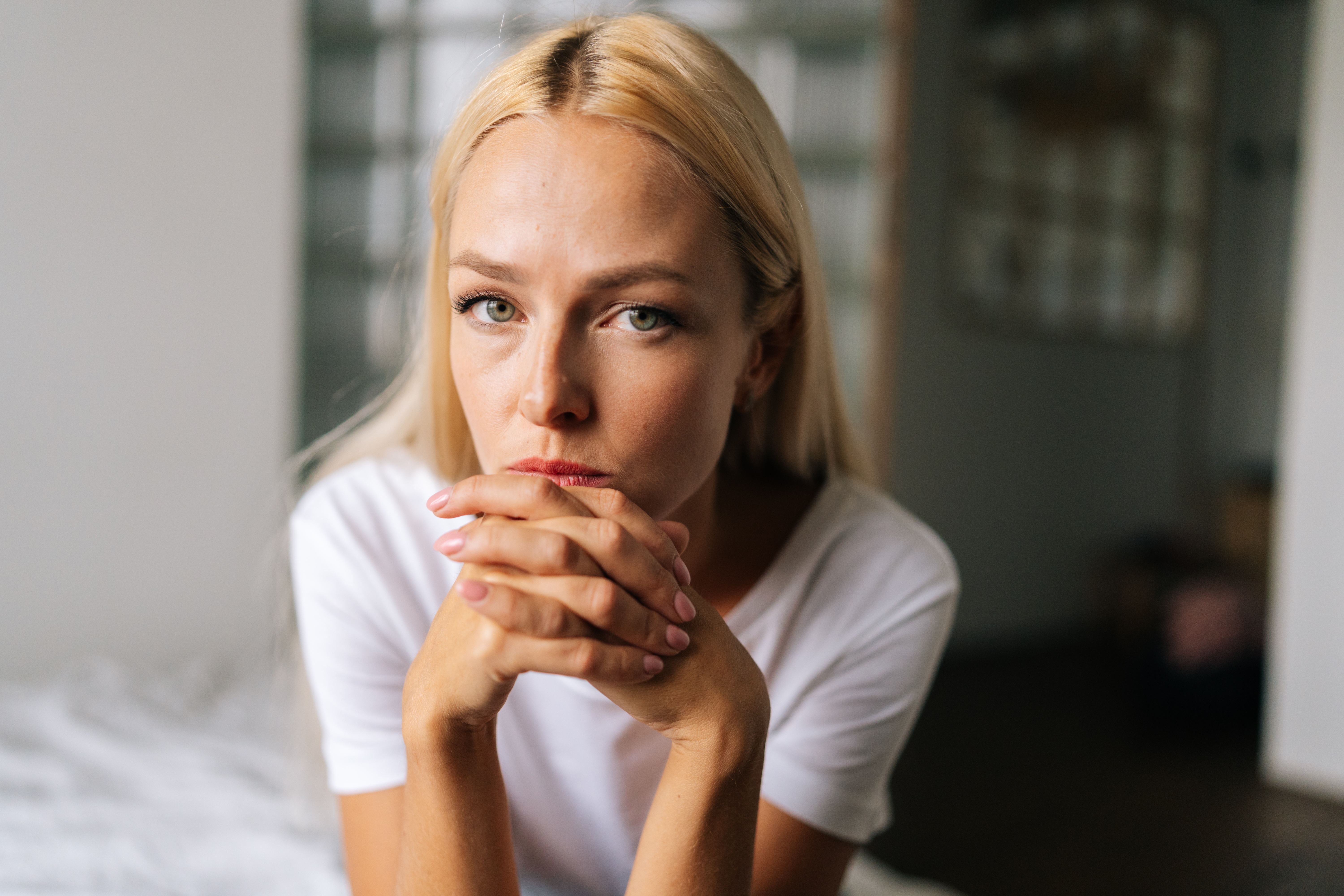 Close,Up,Face,Of,Thoughtful,Blonde,Female,Sitting,Alone,In