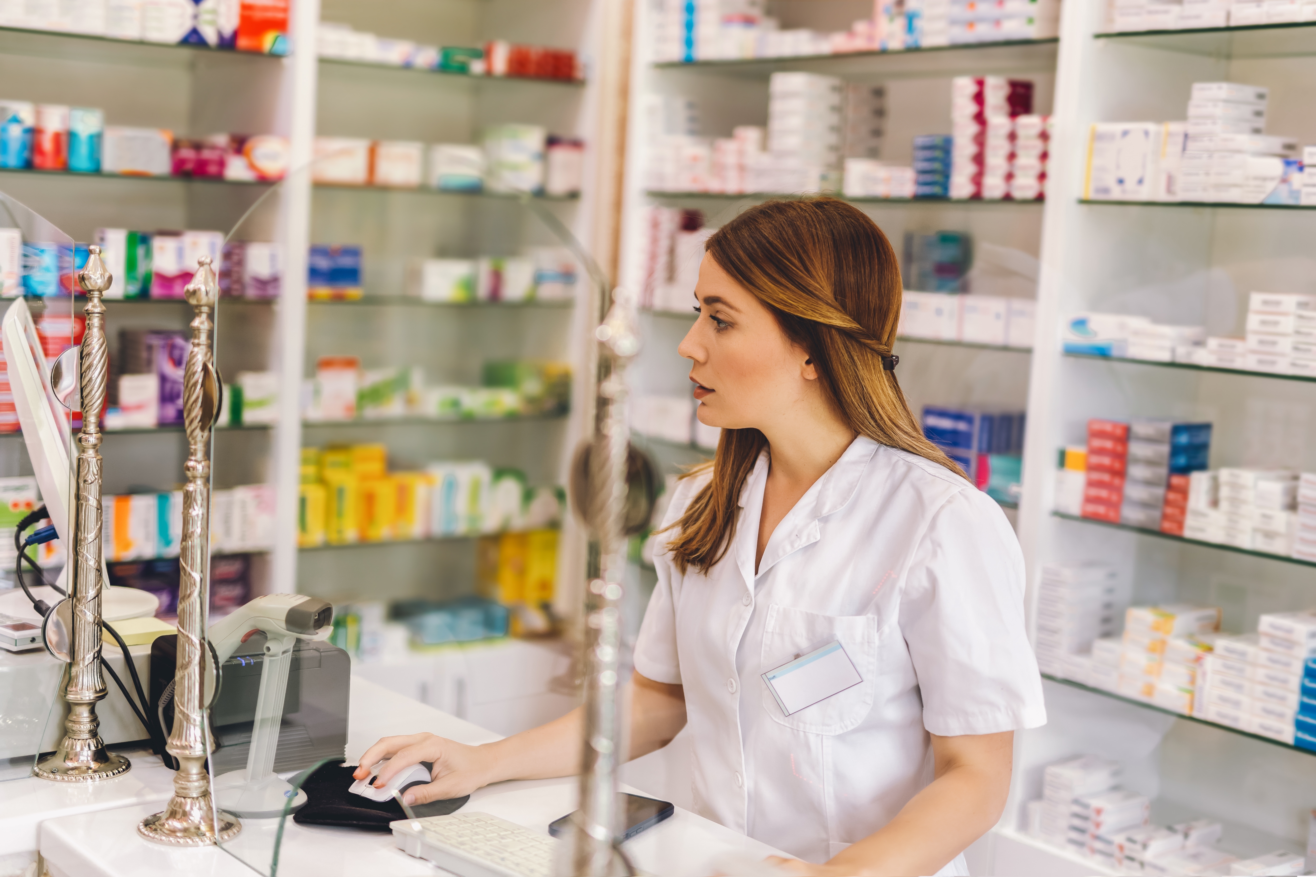 Young,Female,Pharmacist,Working,At,The,Cash,Desk,On,The