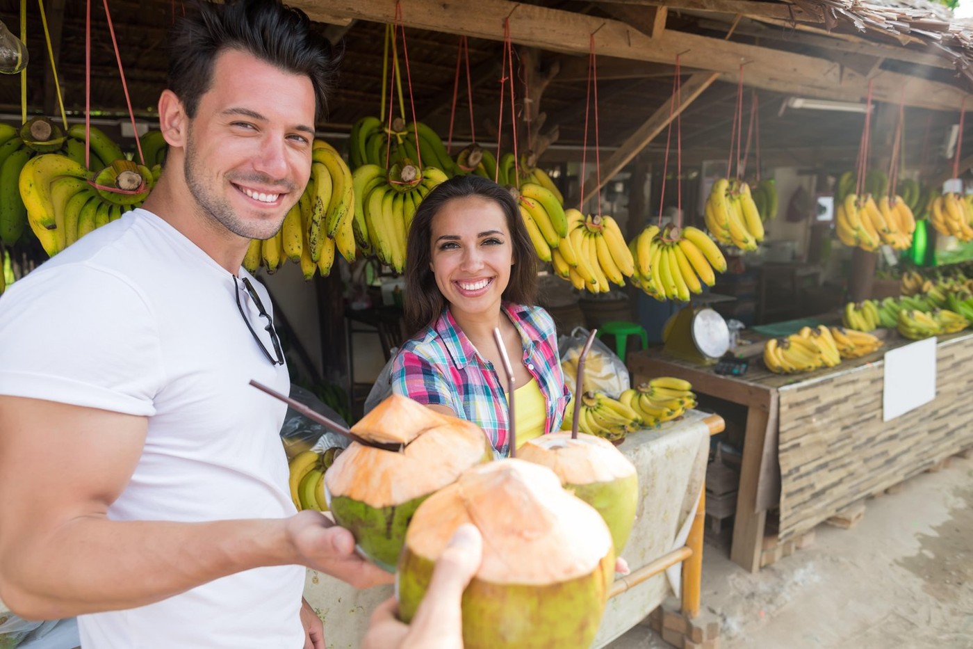 Couple Drink Coconut Cocktail On Street Traditional Fruits Market, Young Man And Woman Travelers,Image: 340361009, License: Royalty-free, Restrictions: , Model Release: yes, Credit line: Ievgen Chepil / Alamy / Alamy / Profimedia