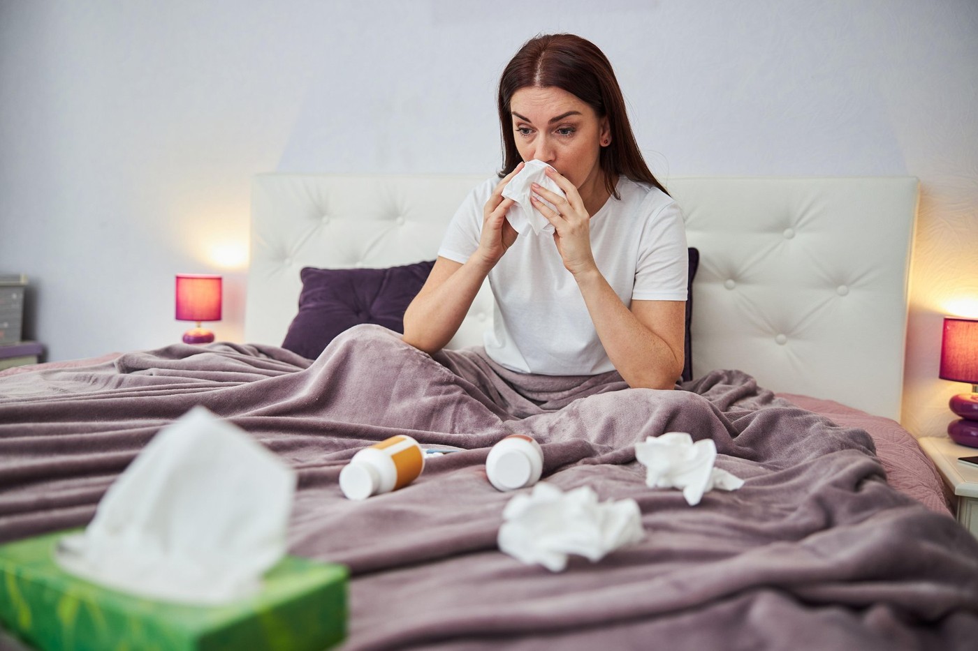 Adult lady cleaning her nose into a napkin with many used papers and pill bottles lying around her,Image: 580315351, License: Royalty-free, Restrictions: , Model Release: yes, Credit line: Svitlana Hulko / Alamy / Alamy / Profimedia