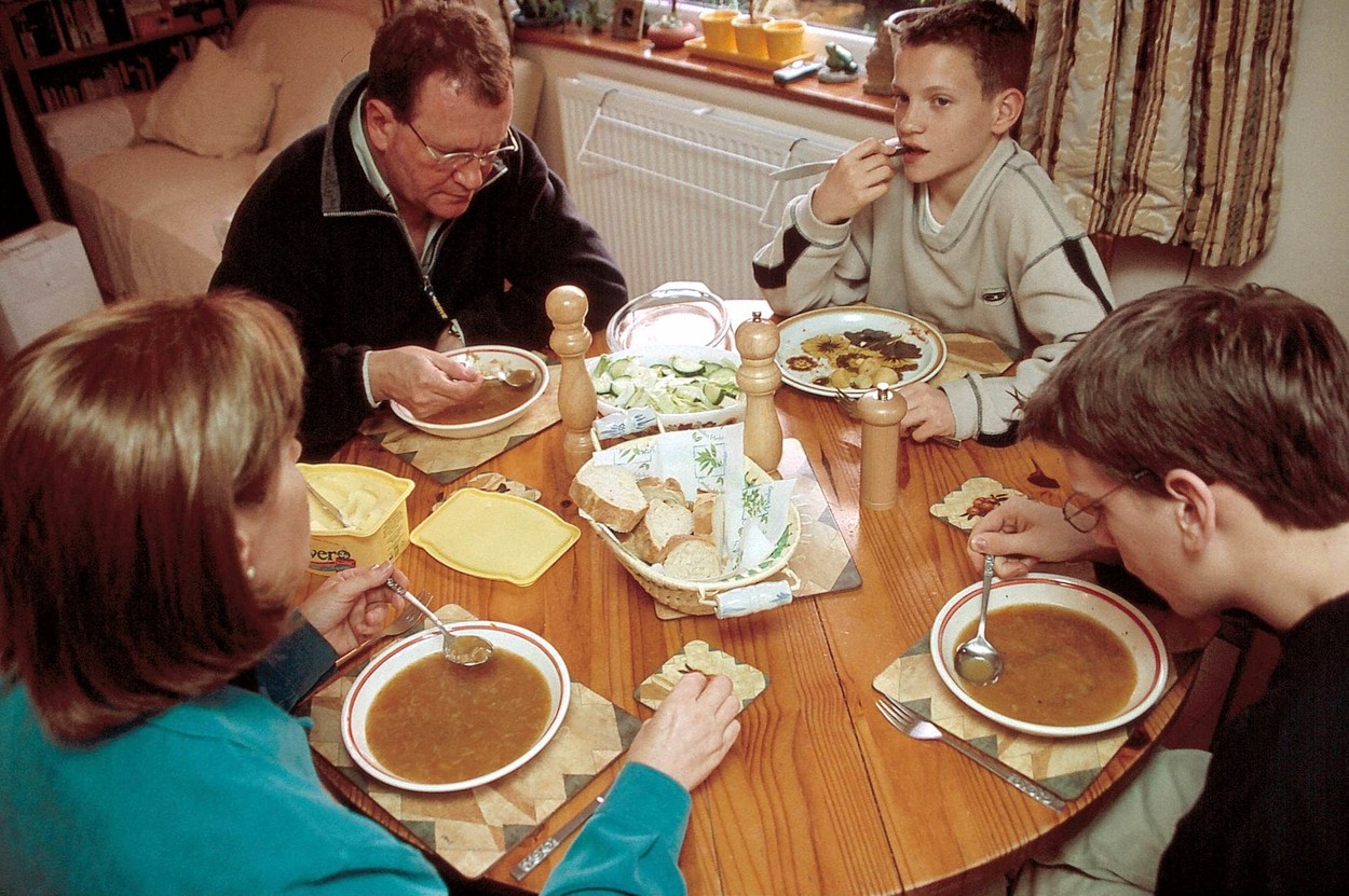 family eating soup at dinner time