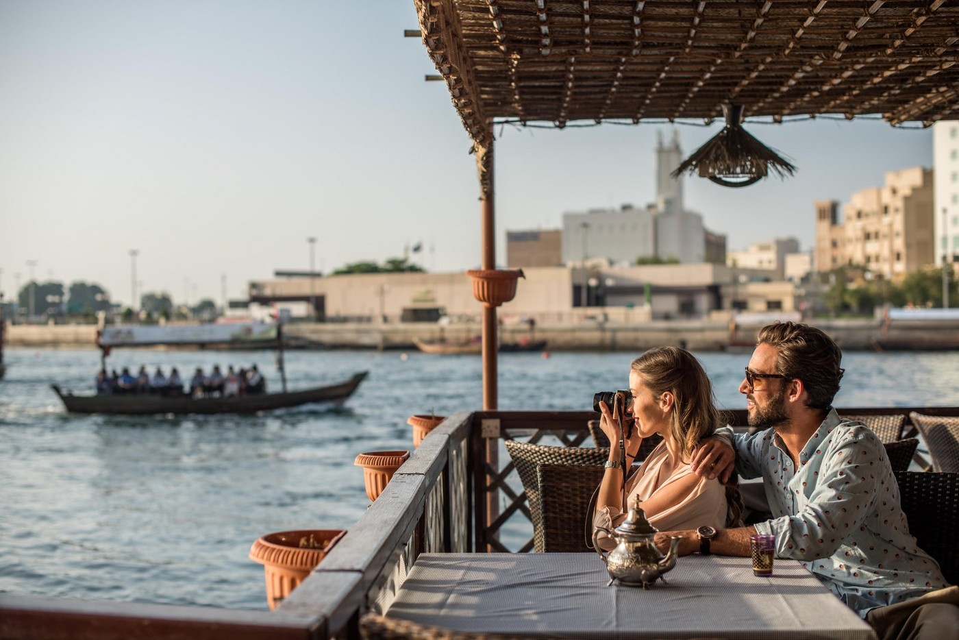 Romantic couple photographing from Dubai marina cafe, United Arab Emirates
