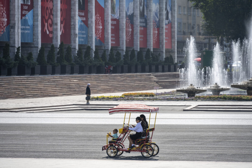 Family in a rickshaw on Ala-Too Square, in Bishkek, Kyrgyzstan,Image: 835365659, License: Royalty-free, Restrictions: , Model Release: no, Credit line: Moritz Wolf / imageBROKER / Profimedia