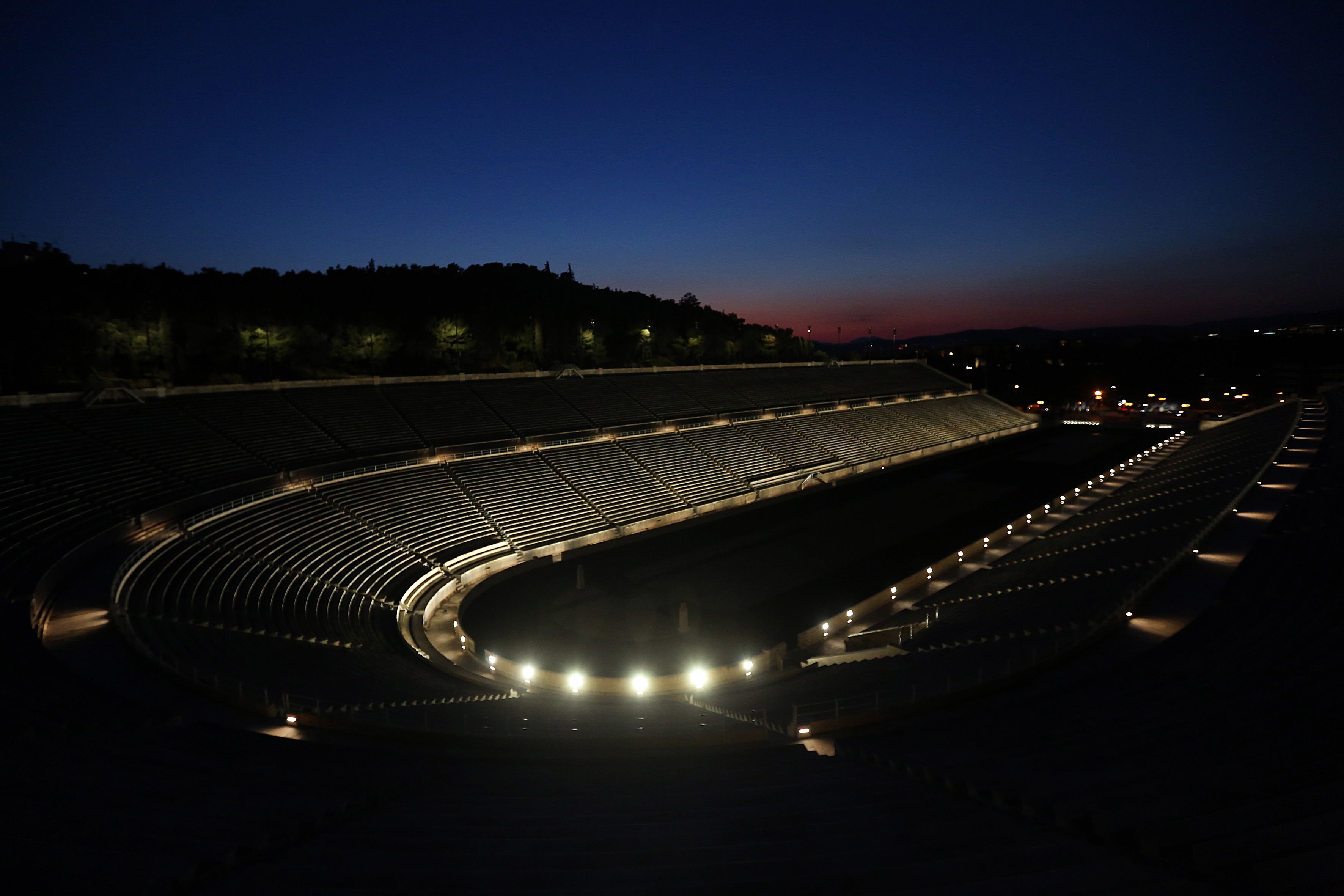 epa09107272 A general view on the Kallimarmaron Panathenaic Stadium of Athens, where the first modern Olympic Games took place, illuminated by the new lighting system, in Athens, Greece, 30 March 2021.  EPA-EFE/ORESTIS PANAGIOTOU