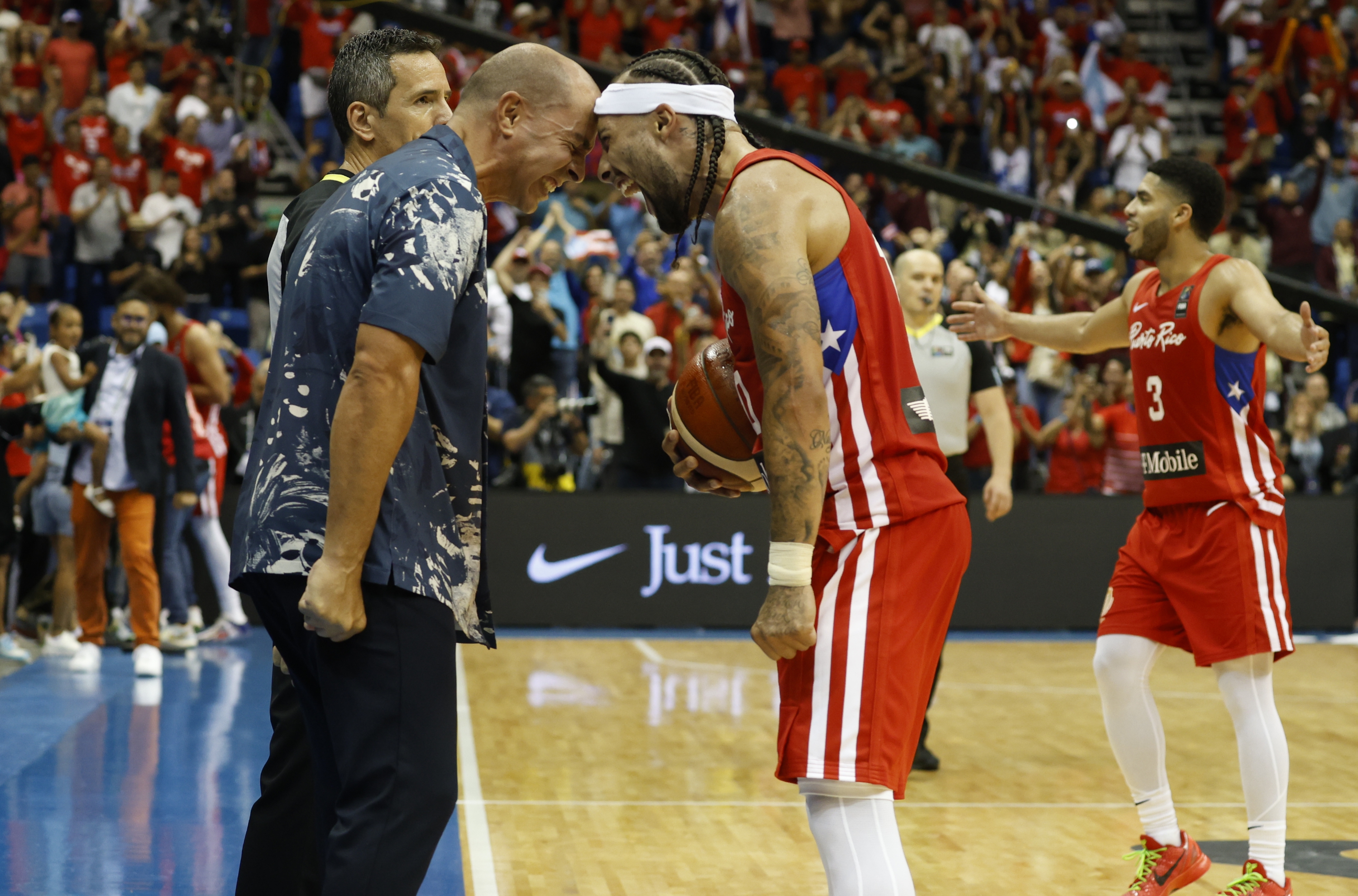 epa11466138 Puerto Rican players Carlos Delgado (L) and Jose Alvarado celebrate after they beat Lithuania during the final of the classification tournament for the Summer Olympics 2024 in San Juan, Puerto Rico, 07 July 2024.  EPA-EFE/THAIS LLORCA