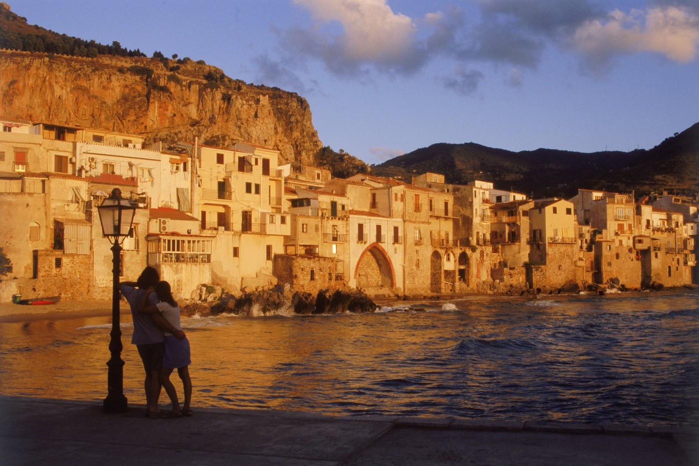 Couple at sunset in village of Cefalu in Sicily