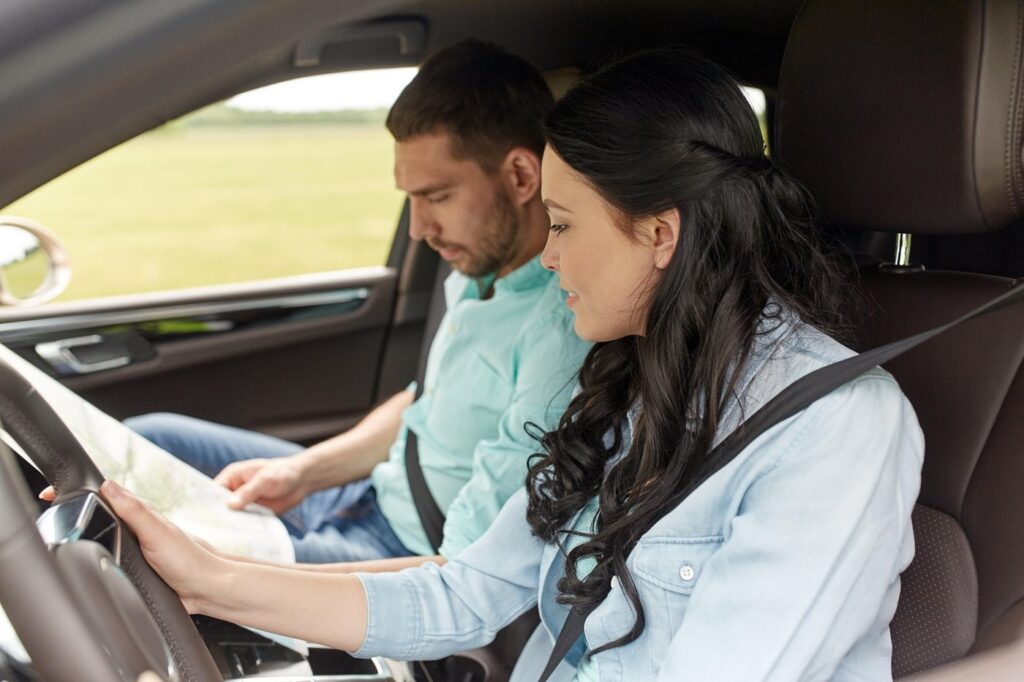 leisure, road trip, travel and people concept - happy man and woman driving in car and searching location on map,Image: 313734812, License: Royalty-free, Restrictions: , Model Release: yes, Credit line: Lev Dolgachov / Alamy / Alamy / Profimedia