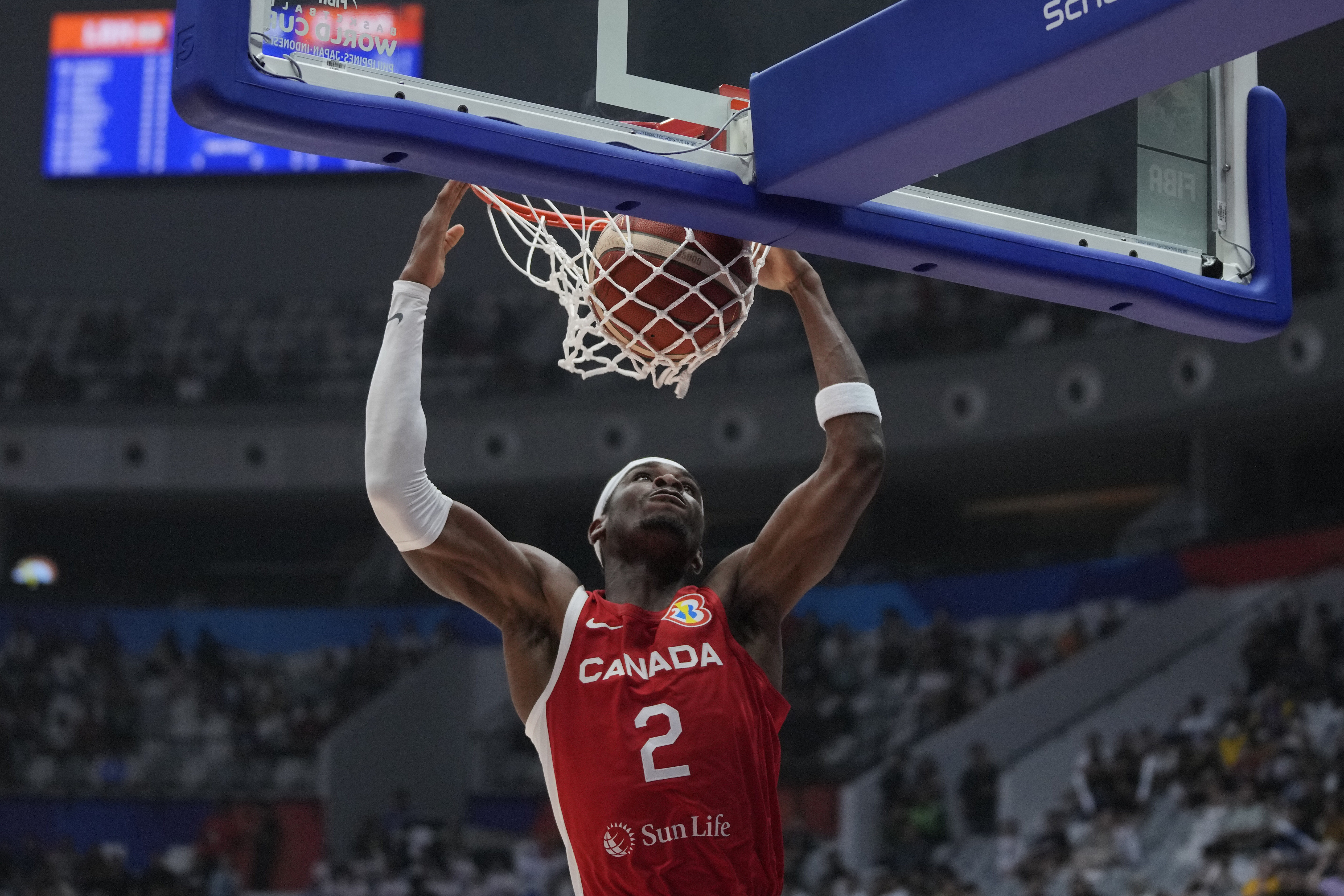 Canada guard Shai Gilgeous-Alexander (2) dunks to score against Lebanon during the Basketball World Cup group H match between Canada and Lebanon at the Indonesia Arena stadium in Jakarta, Indonesia, Sunday, Aug. 27, 2023. (AP Photo/Dita Alangkara)