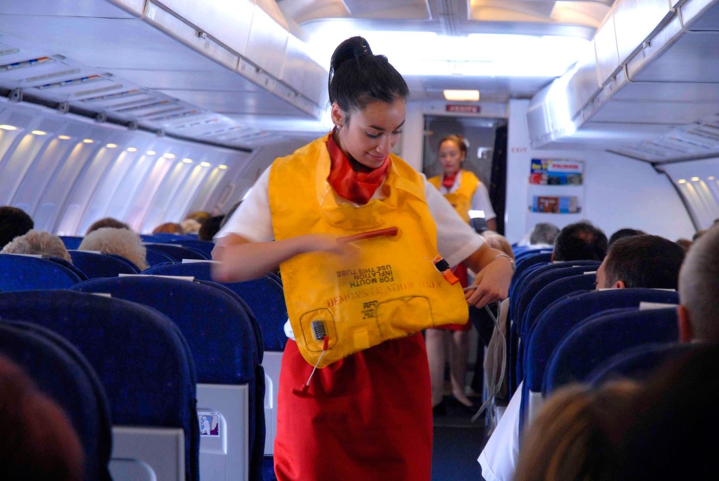 Passenger jet cabin crew demonstrate how to put on a lifejacket in the case of an emergency,Image: 10947356, License: Rights-managed, Restrictions: , Model Release: no, Credit line: Jack Sullivan / Alamy / Profimedia