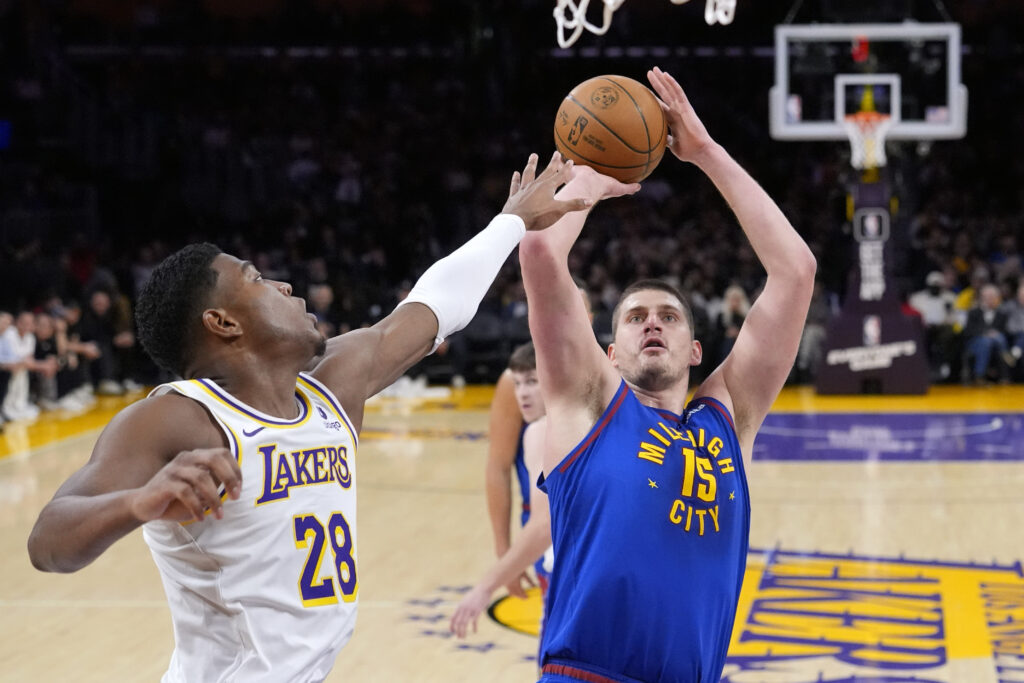 Denver Nuggets center Nikola Jokic, right, shoots as Los Angeles Lakers forward Rui Hachimura defends during the first half of an NBA basketball game Saturday, March 2, 2024, in Los Angeles. (AP Photo/Mark J. Terrill)