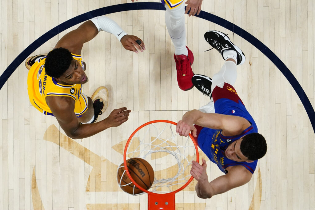 Denver Nuggets forward Michael Porter Jr. (1) dunks as Los Angeles Lakers forward Rui Hachimura looks on during the second half of Game 1 of the NBA basketball Western Conference Finals series, Tuesday, May 16, 2023, in Denver. (AP Photo/Jack Dempsey)
