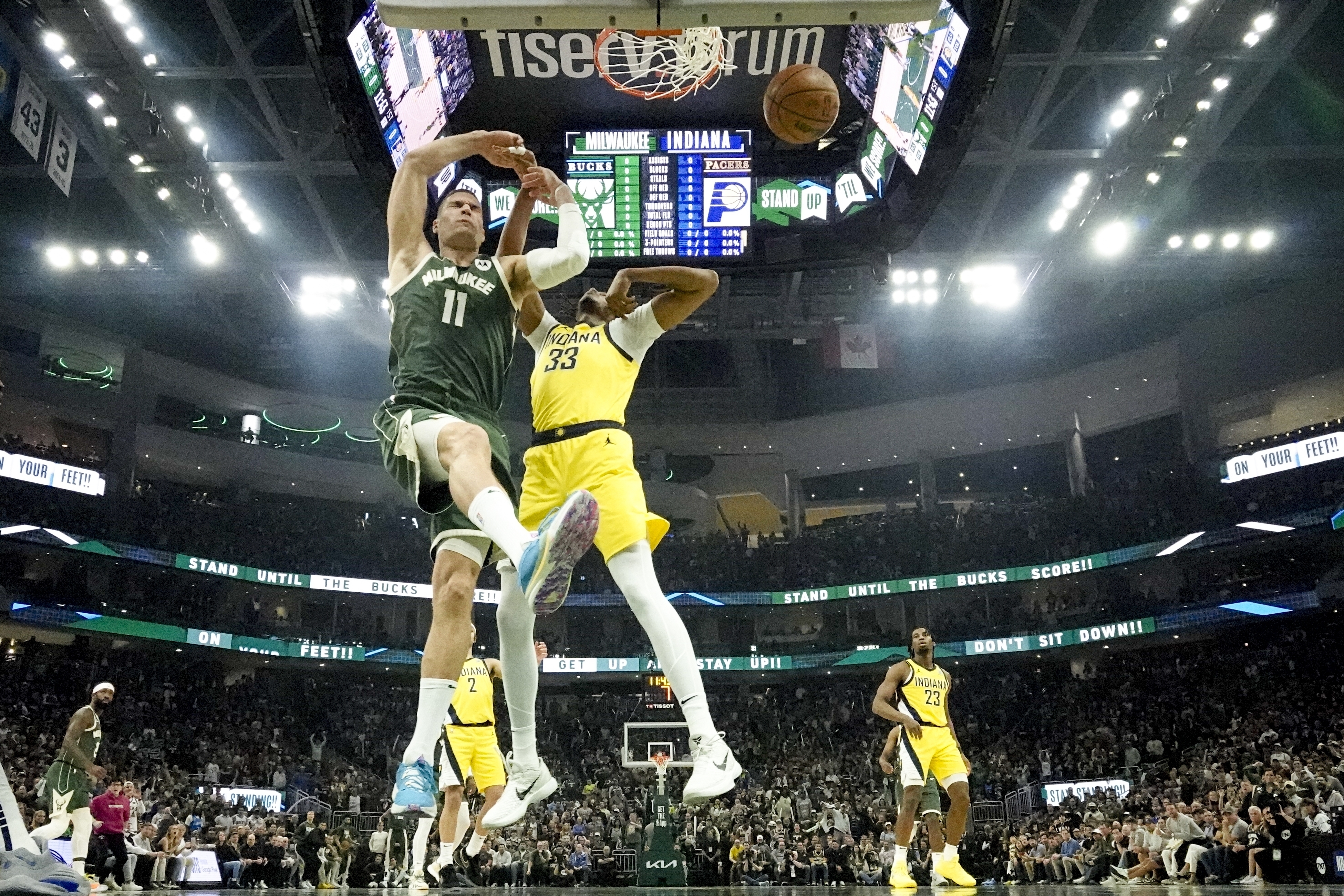 Milwaukee Bucks' Brook Lopez dunks past Indiana Pacers' Myles Turner during the first half of Game 5 of an NBA basketball series Tuesday, April 30, 2024, in Milwaukee. The Bucks won 115-92. The Pacers lead the series 3-2. (AP Photo/Morry Gash)