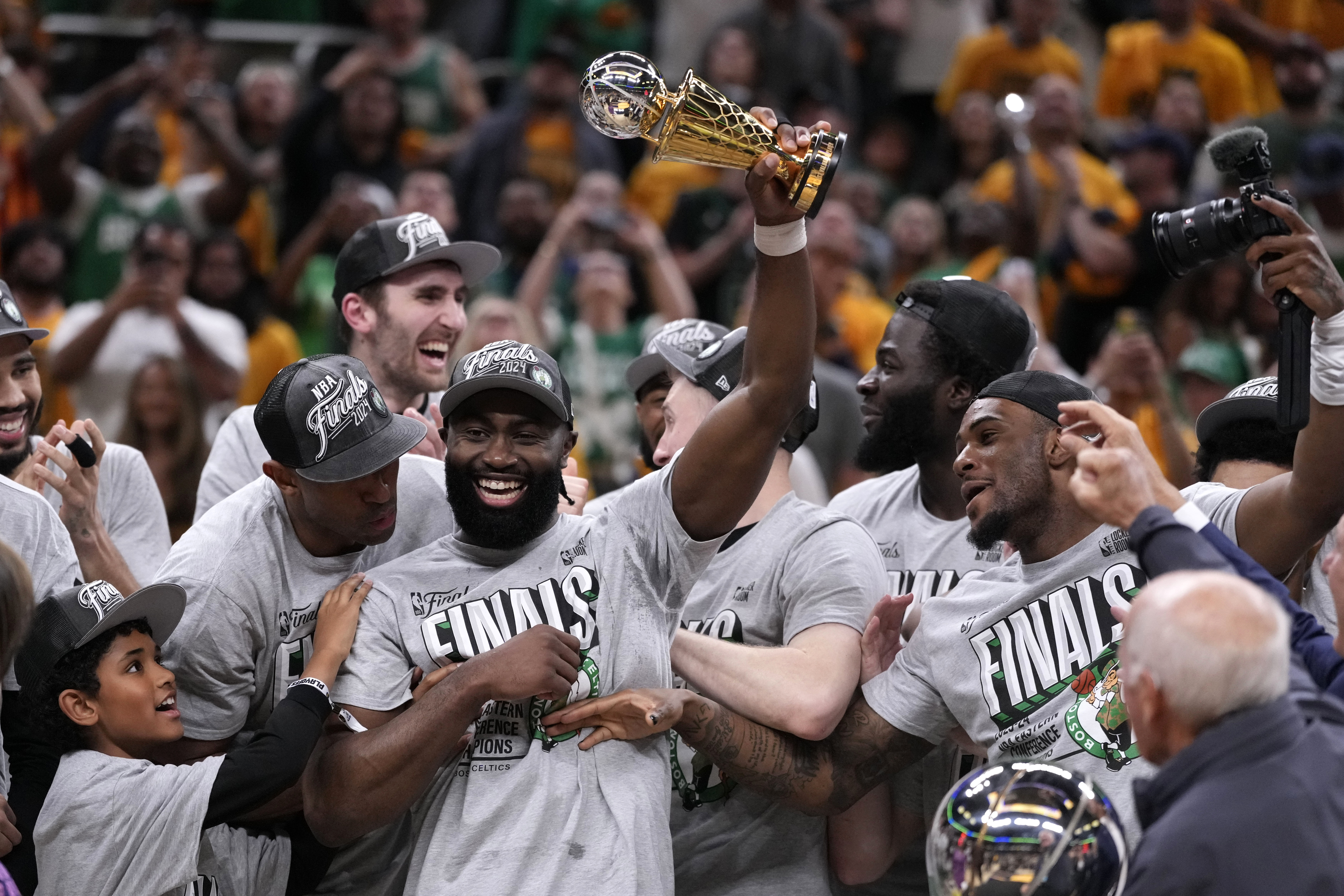 Boston Celtics guard Jaylen Brown, center, celebrates with his teammates after Game 4 of the NBA Eastern Conference basketball finals against the Indiana Pacers, Monday, May 27, 2024, in Indianapolis. The Celtics won 105-102.(AP Photo/Michael Conroy)
