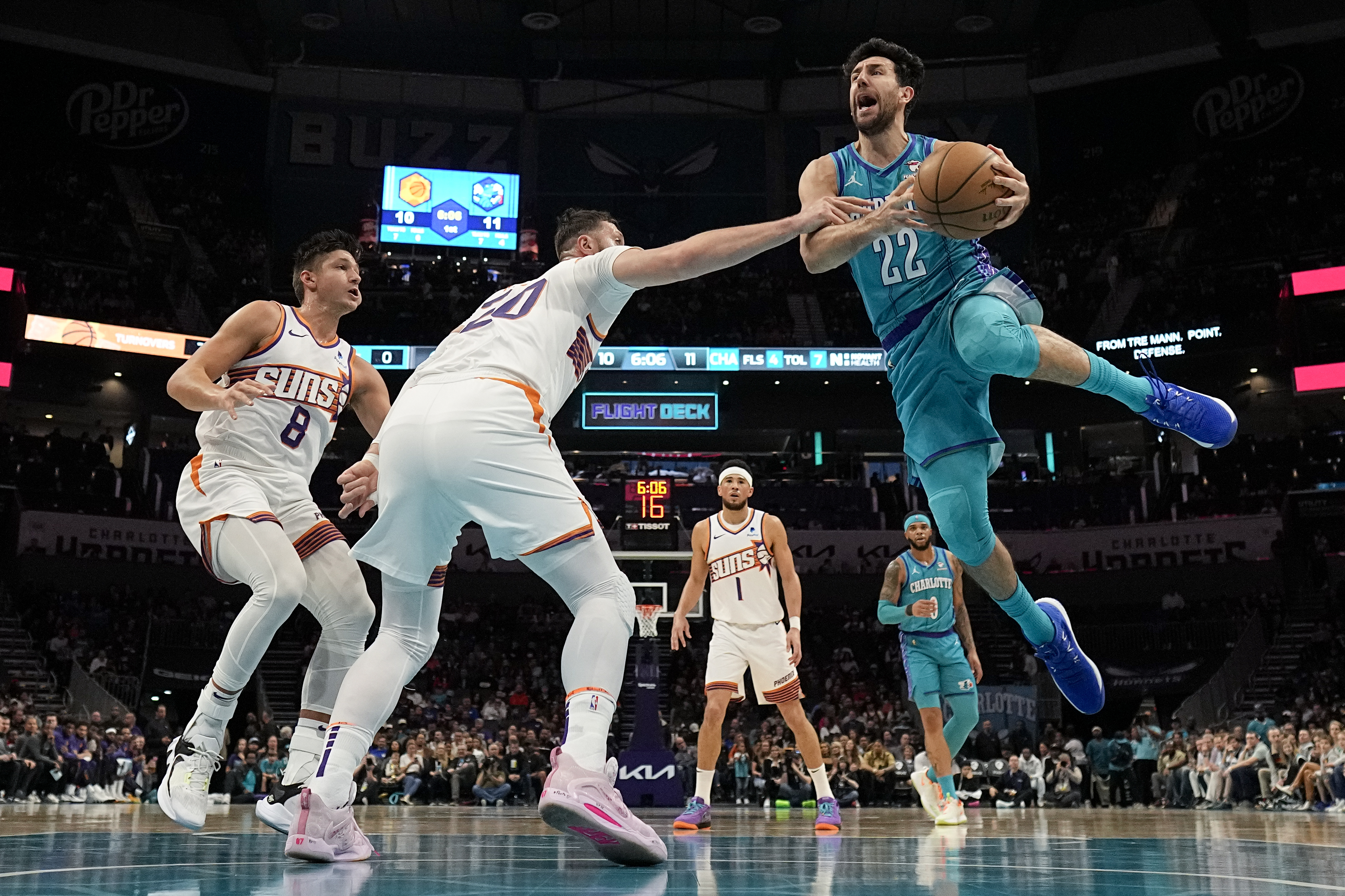 Charlotte Hornets guard Vasa Micic, is fouled by Phoenix Suns center Jusuf Nurkic during the first half of an NBA basketball game on Friday, March 15, 2024, in Charlotte, N.C. (AP Photo/Chris Carlson)
