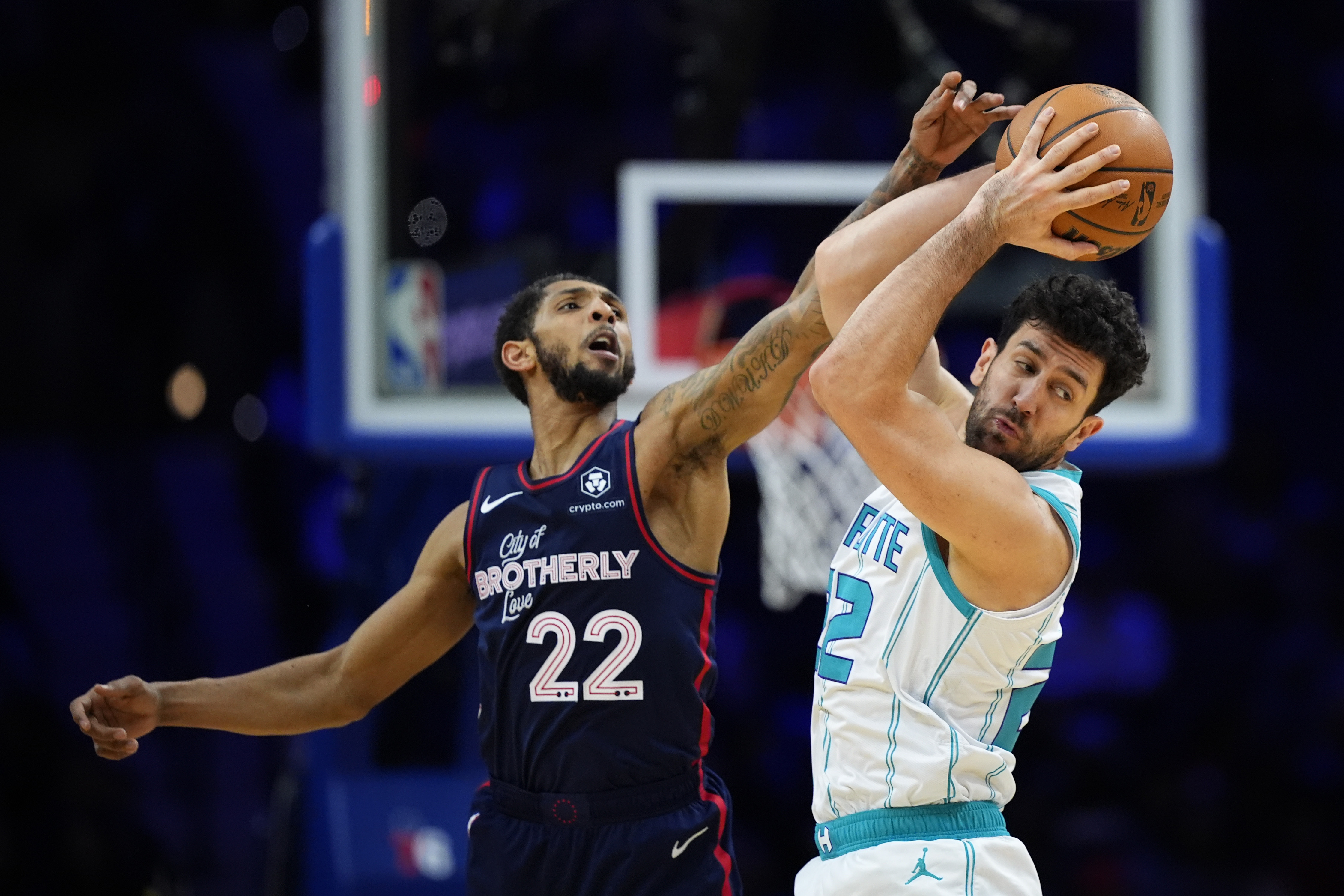 Charlotte Hornets' Vasa Micic, right, pulls a pass away from Philadelphia 76ers' Cameron Payne during the first half of an NBA basketball game, Saturday, March 16, 2024, in Philadelphia. (AP Photo/Matt Slocum)