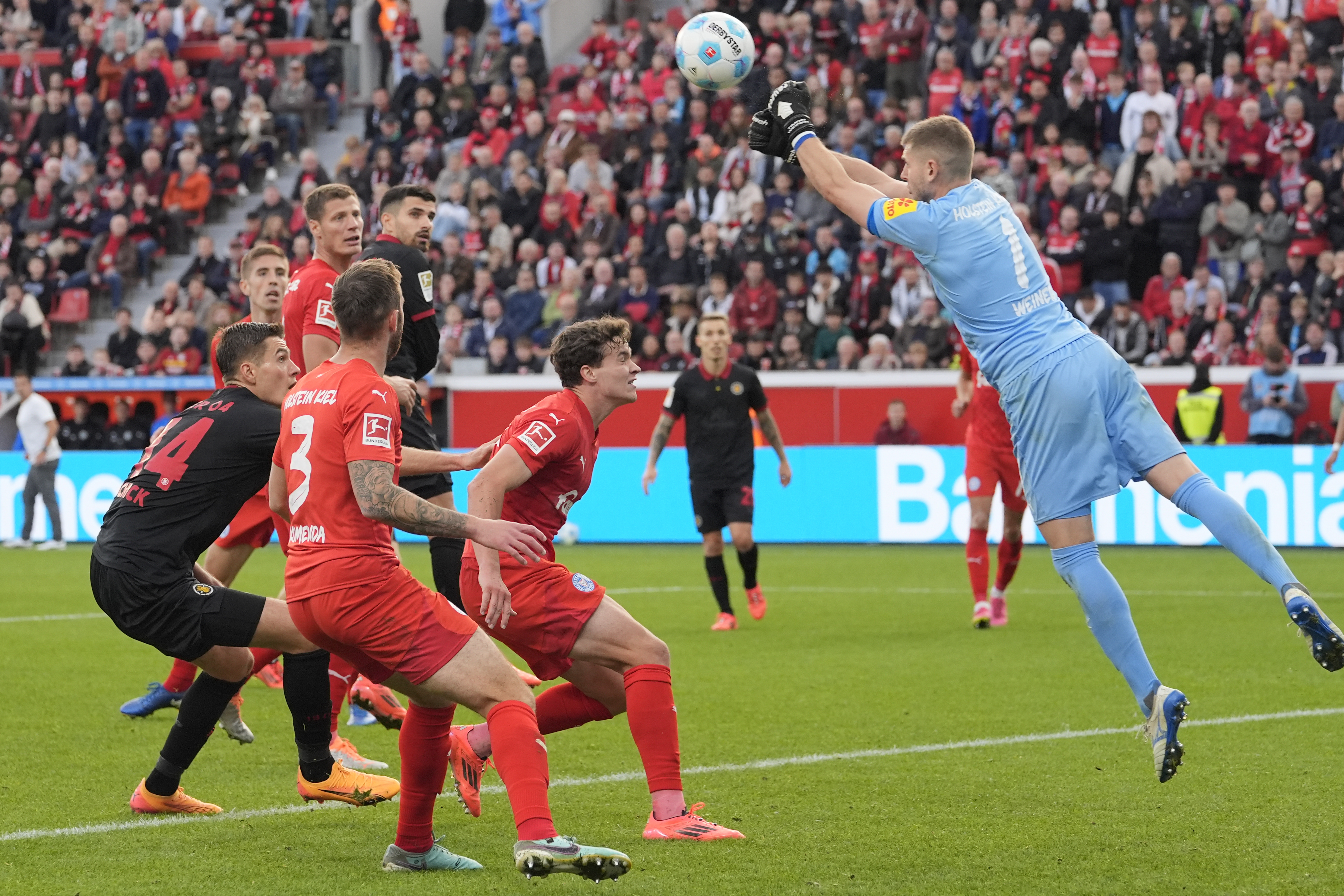 Kiel's goalkeeper Timon Weiner punches out the ball during the German Bundesliga soccer match between Bayer Leverkusen and Holstein Kiel at the BayArena in Leverkusen, Germany, Saturday, Oct. 5, 2024. (AP Photo/Martin Meissner)
