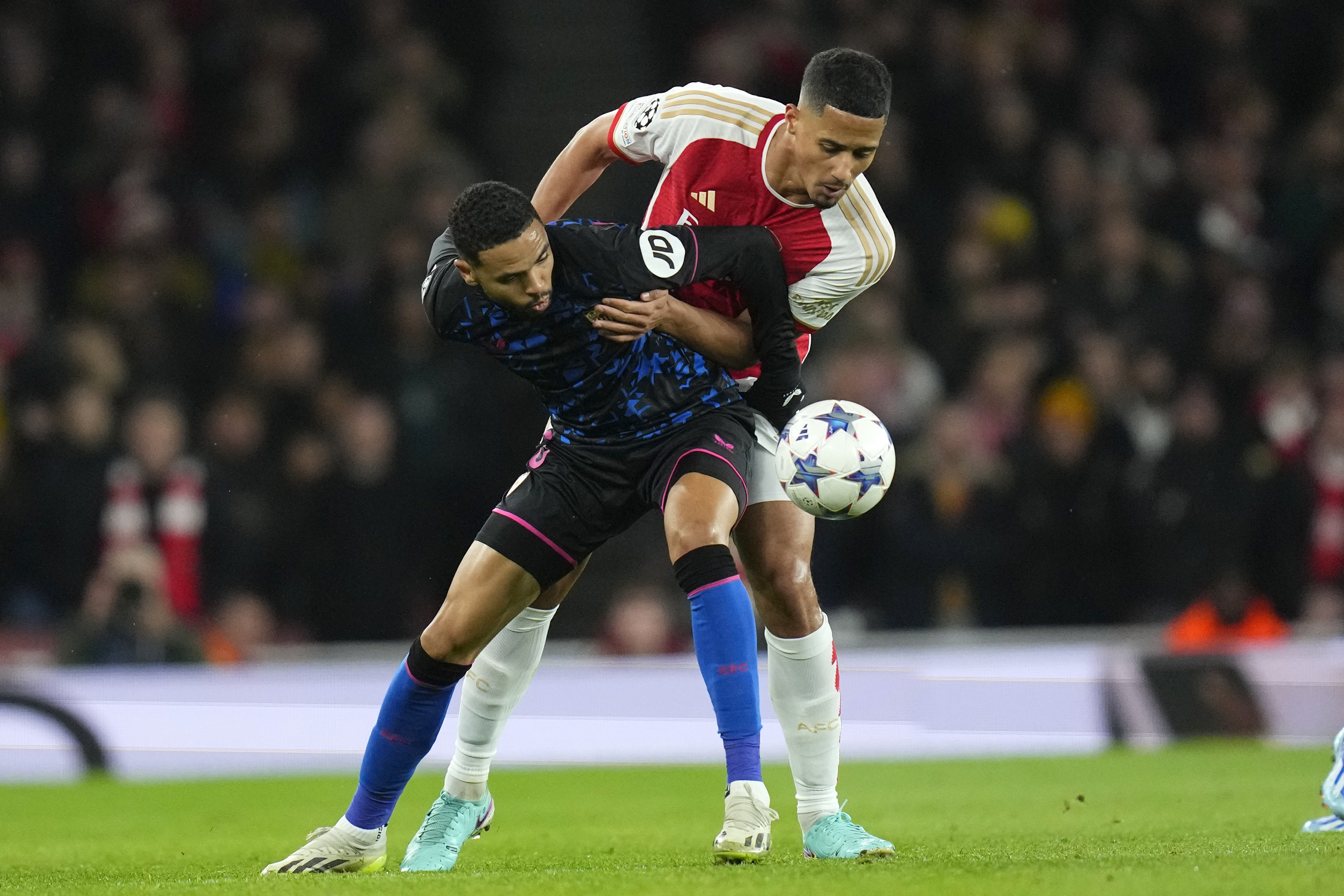 Arsenal's William Saliba, right, and Sevilla's Youssef En-Nesyri vie for the ball during the Champions League Group B soccer match between Arsenal and Sevilla at Emirates stadium in London Wednesday, Nov. 8, 2023. (AP Photo/Kirsty Wigglesworth)