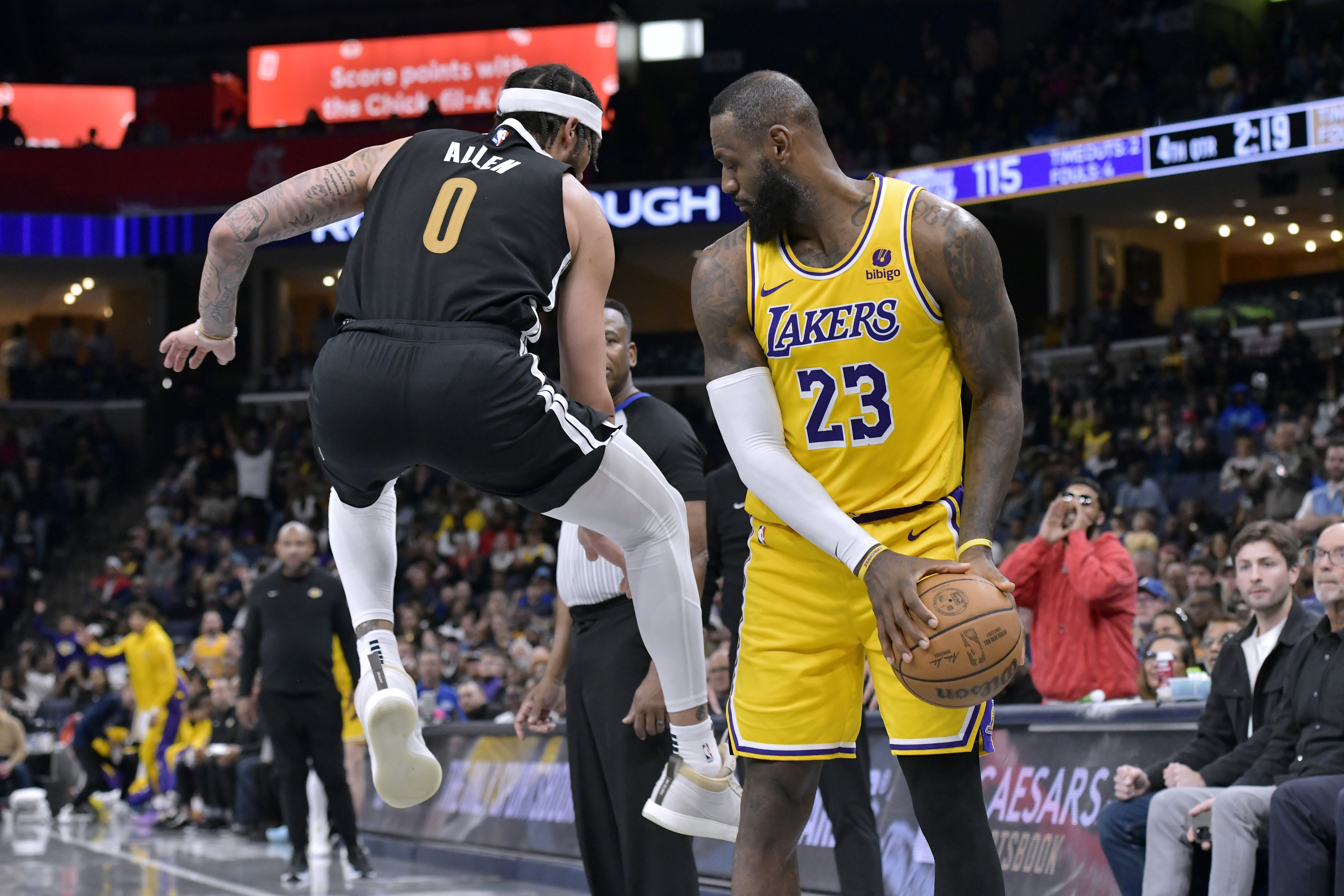 Los Angeles Lakers forward LeBron James (23) watches Memphis Grizzlies forward Timmy Allen (0) jump by on defense during the second half of an NBA basketball game Friday, April 12, 2024, in Memphis, Tenn. (AP Photo/Brandon Dill)