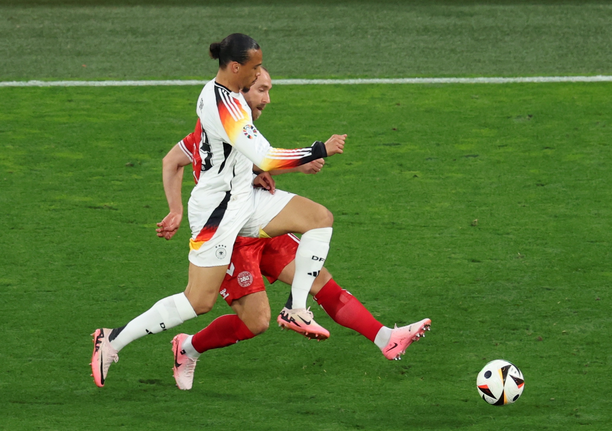 epa11445937 Leroy Sane (front) of Germany and Christian Eriksen of Denmark in action during the UEFA EURO 2024 Round of 16 soccer match between Germany and Denmark, in Dortmund, Germany, 29 June 2024.  EPA-EFE/GEORGI LICOVSKI