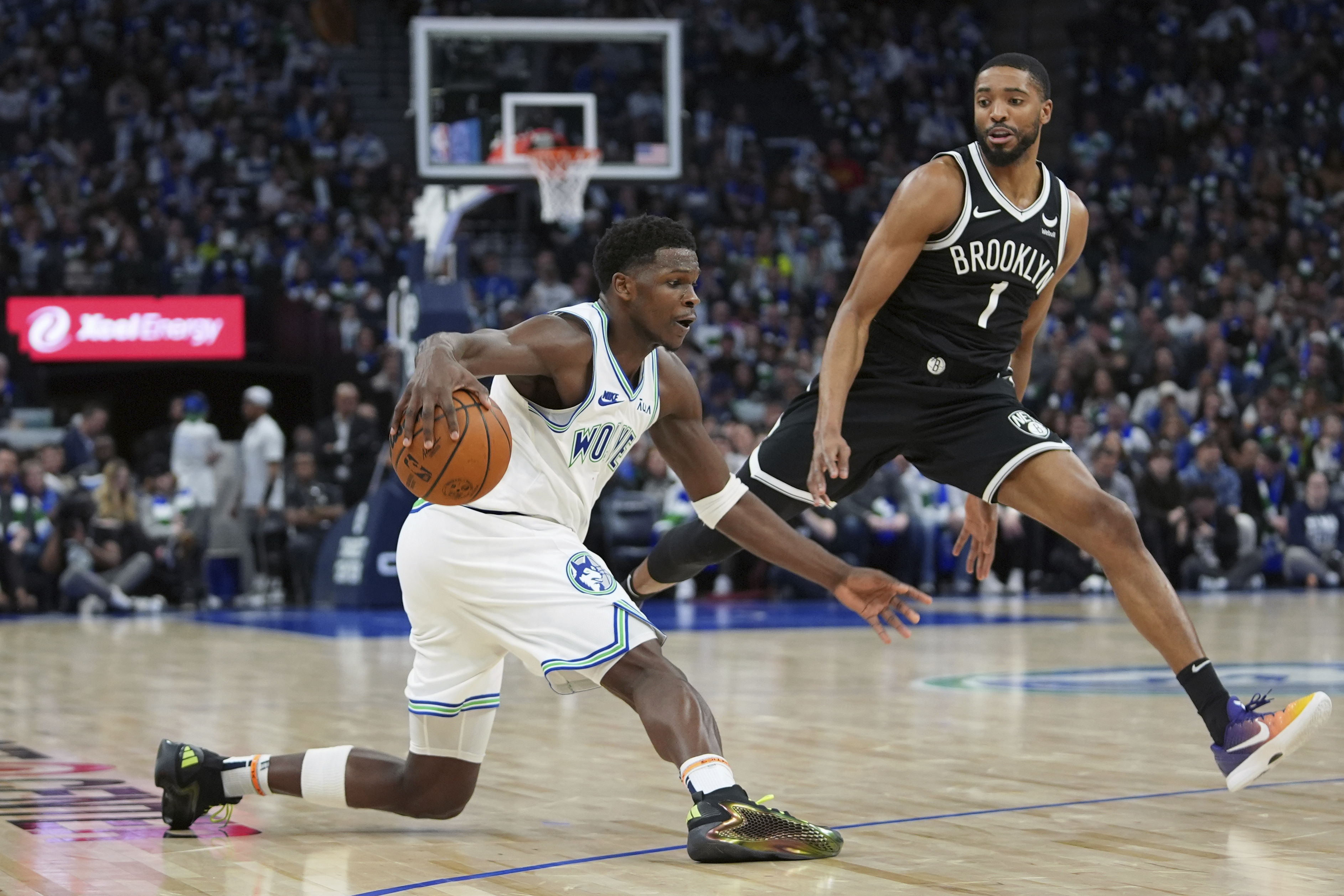 Minnesota Timberwolves guard Anthony Edwards works toward the basket as Brooklyn Nets forward Mikal Bridges (1) defends during the second half of an NBA basketball game Saturday, Feb. 24, 2024, in Minneapolis. (AP Photo/Abbie Parr)