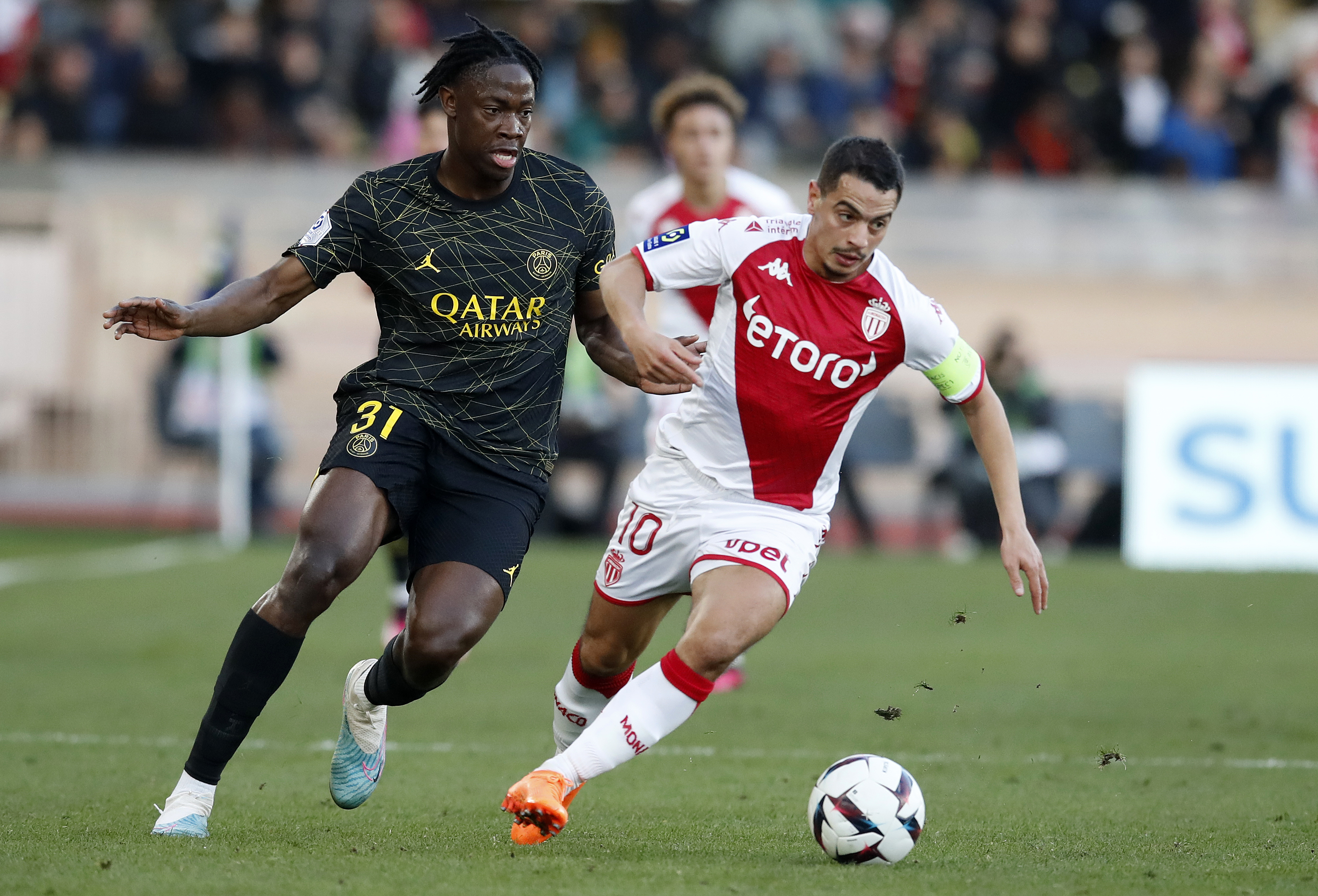 epa10461173 Wissam Ben Yeder (R) of AS Monaco and El Chadaille Bitshiabu (L) of Paris Saint-Germain in action during the French Ligue 1 soccer match between AS Monaco and Paris Saint-Germain, in Monaco, 11 February 2023.  EPA-EFE/SEBASTIEN NOGIER