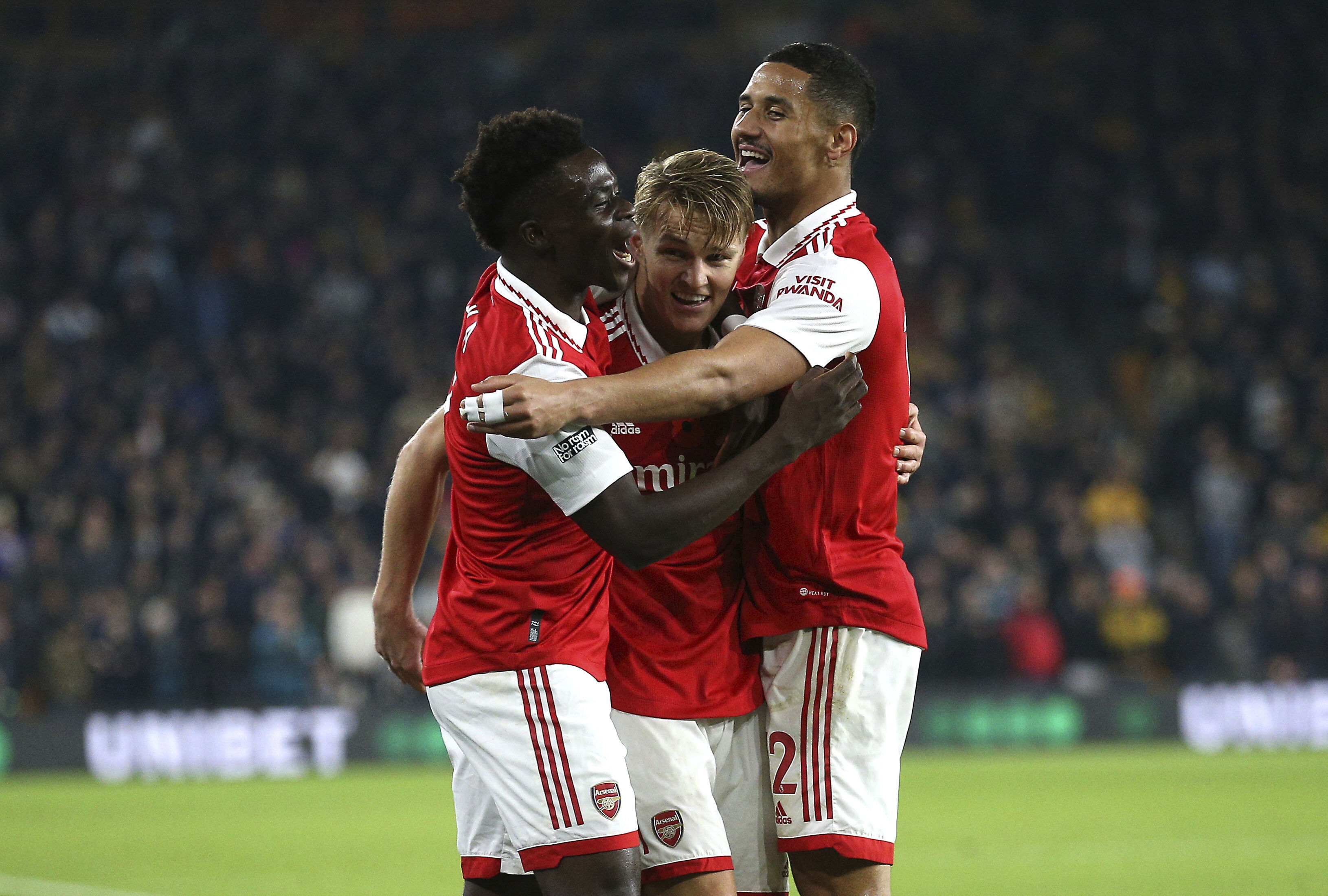 Arsenal's Martin Odegaard, center, celebrates scoring against Arsenal with teammates during the English Premier League soccer match at Molineux, Wolverhampton, England, Saturday Nov. 12, 2022. (Nigel French/PA via AP)