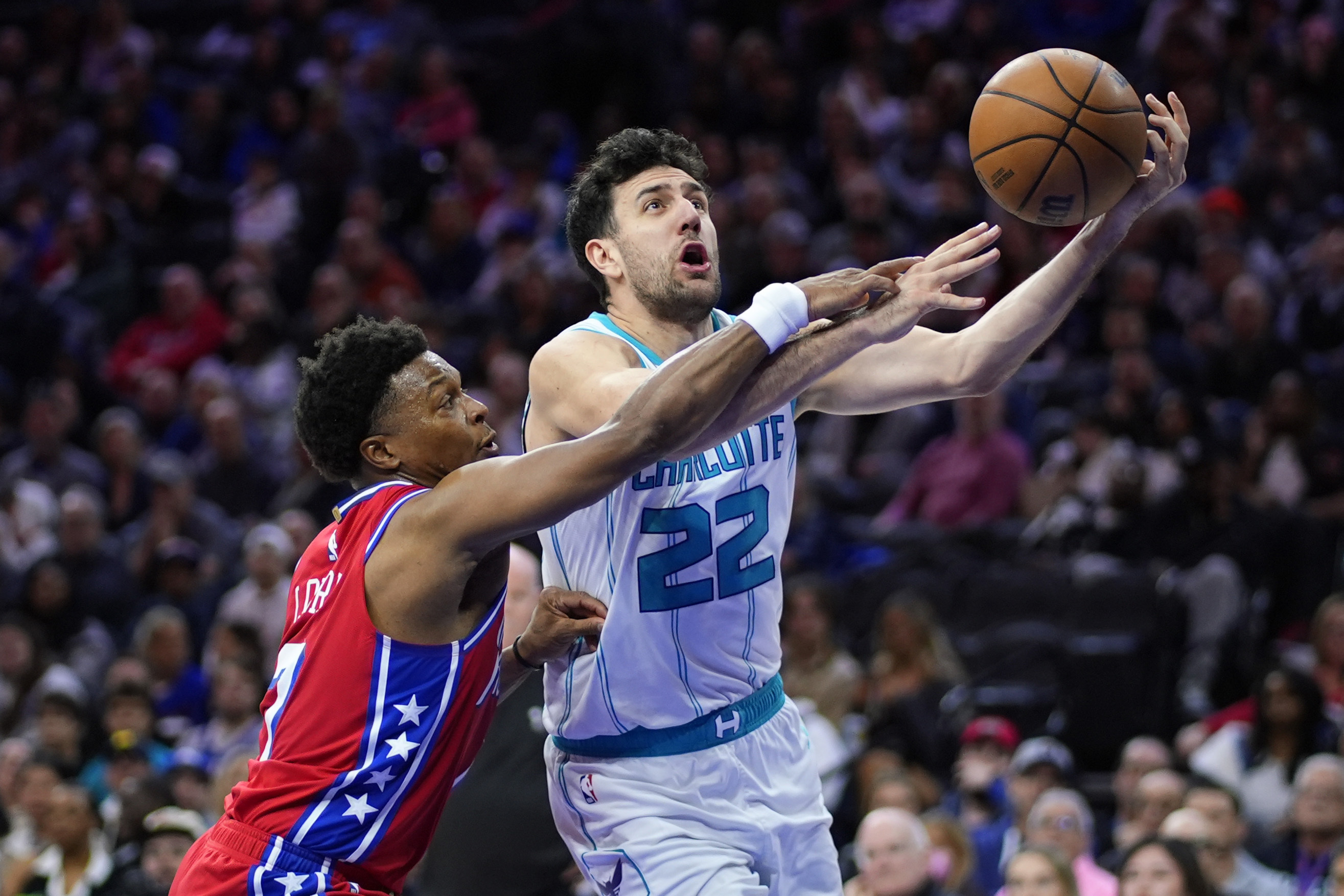 Charlotte Hornets' Vasa Micic, right, goes up for a shot against Philadelphia 76ers' Kyle Lowry during the second half of an NBA basketball game, Friday, March 1, 2024, in Philadelphia. (AP Photo/Matt Slocum)