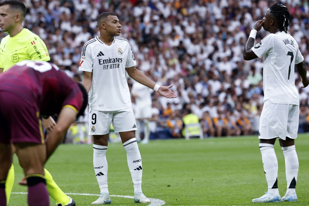 epa11564494 Real Madrid's Kylian Mbappe talks with his teammate Vinicius Jr. (R) during the Spanish LaLiga soccer match between Real Madrid and Real Valladolid, in Madrid, Spain, 25 August 2024.  EPA-EFE/Chema Moya
