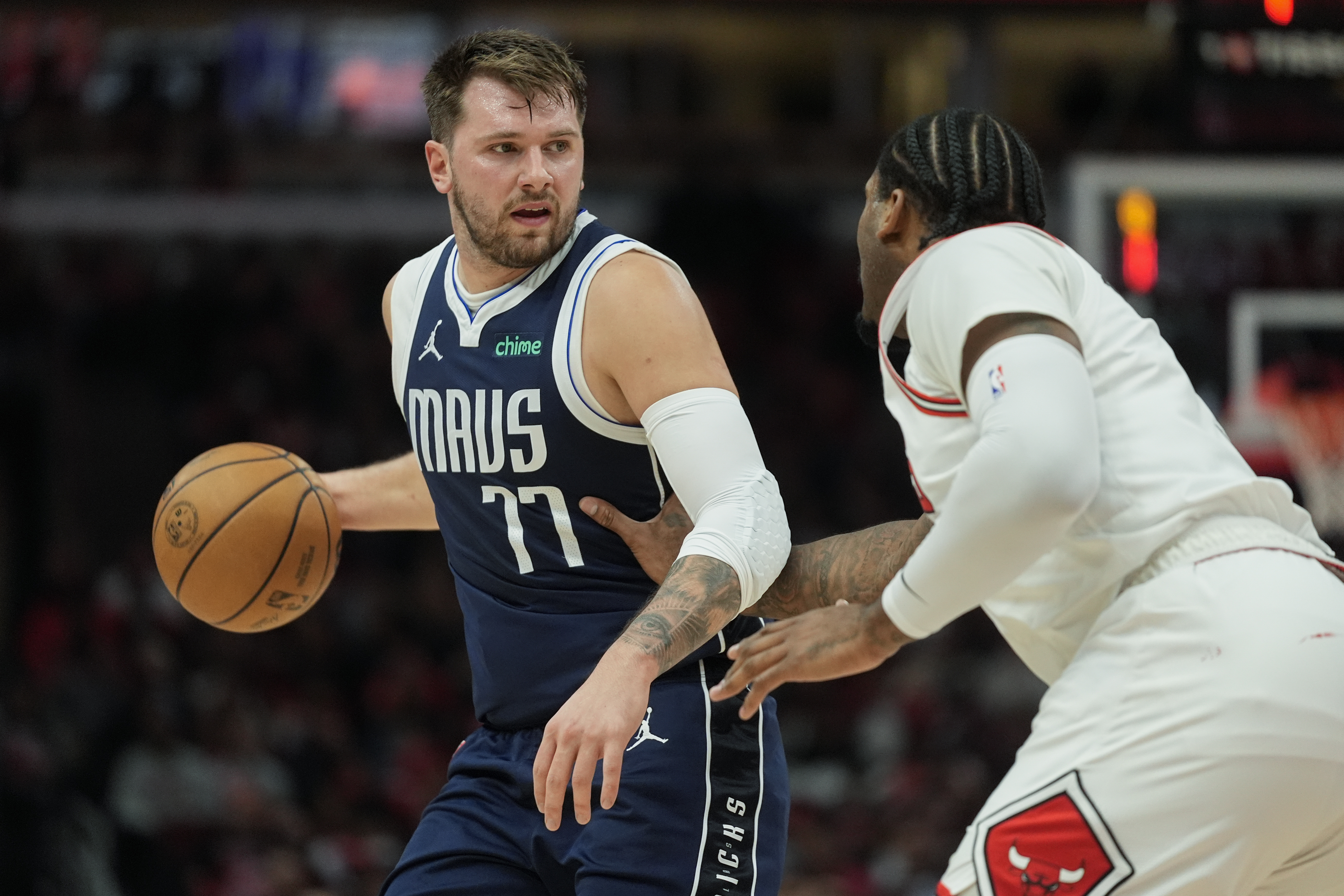 Chicago Bulls center Andre Drummond, right, guards against Dallas Mavericks guard Luka Doncic, left, during the first half of an NBA basketball game Monday, March 11, 2024, in Chicago. (AP Photo/Erin Hooley)