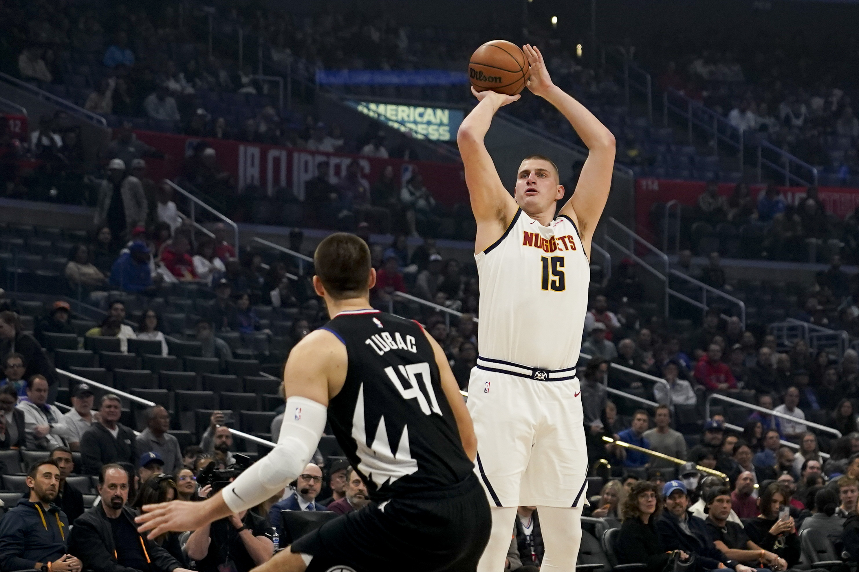 Denver Nuggets center Nikola Jokic, right, shoots against Los Angeles Clippers center Ivica Zubac during the first half of an NBA basketball game, Wednesday, Dec. 6, 2023, in Los Angeles. (AP Photo/Ryan Sun)