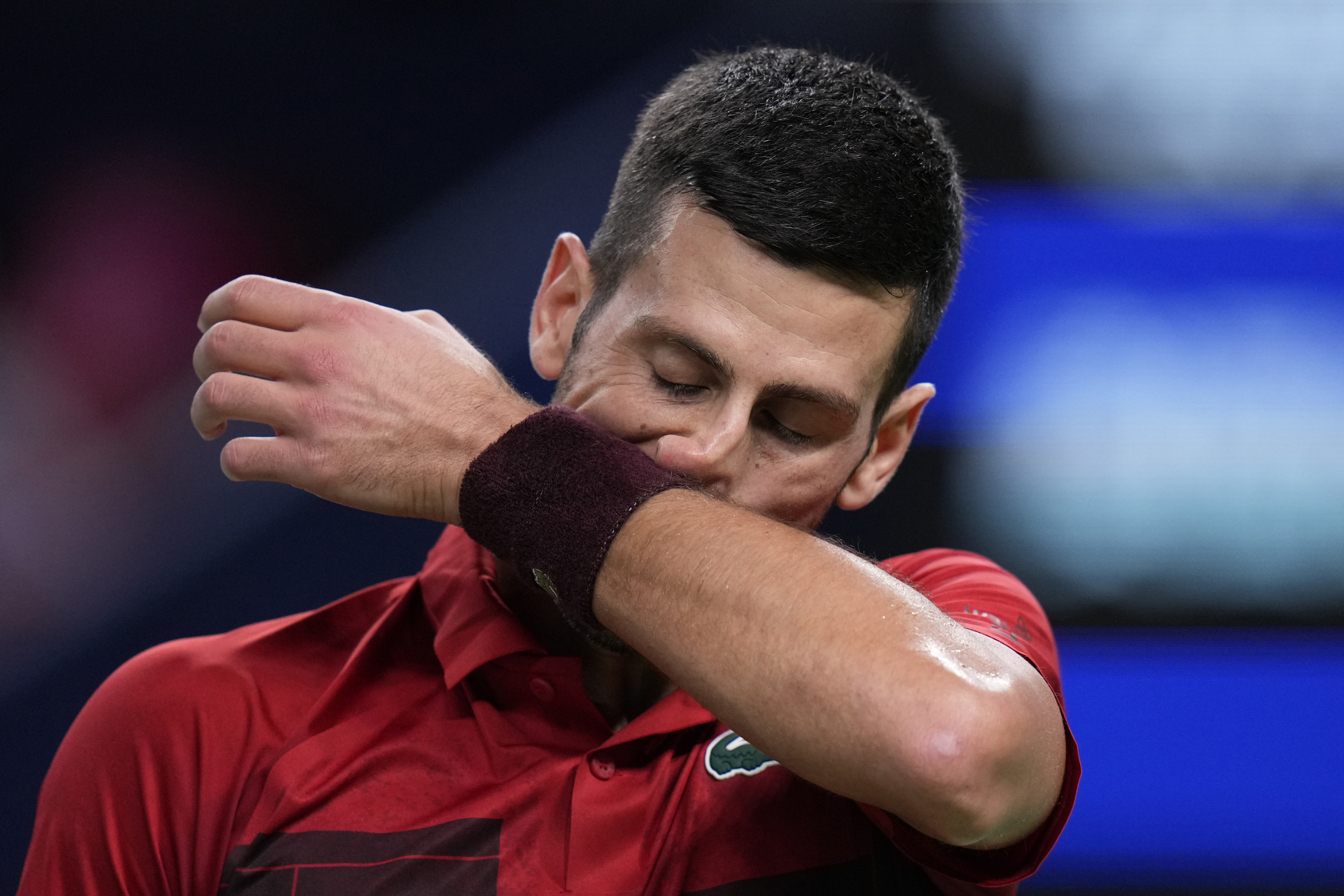 Novak Djokovic of Serbia reacts during the men's singles finals match against Jannik Sinner of Italy in the Shanghai Masters tennis tournament at Qizhong Forest Sports City Tennis Center in Shanghai, China, Sunday, Oct. 13, 2024. (AP Photo/Andy Wong)