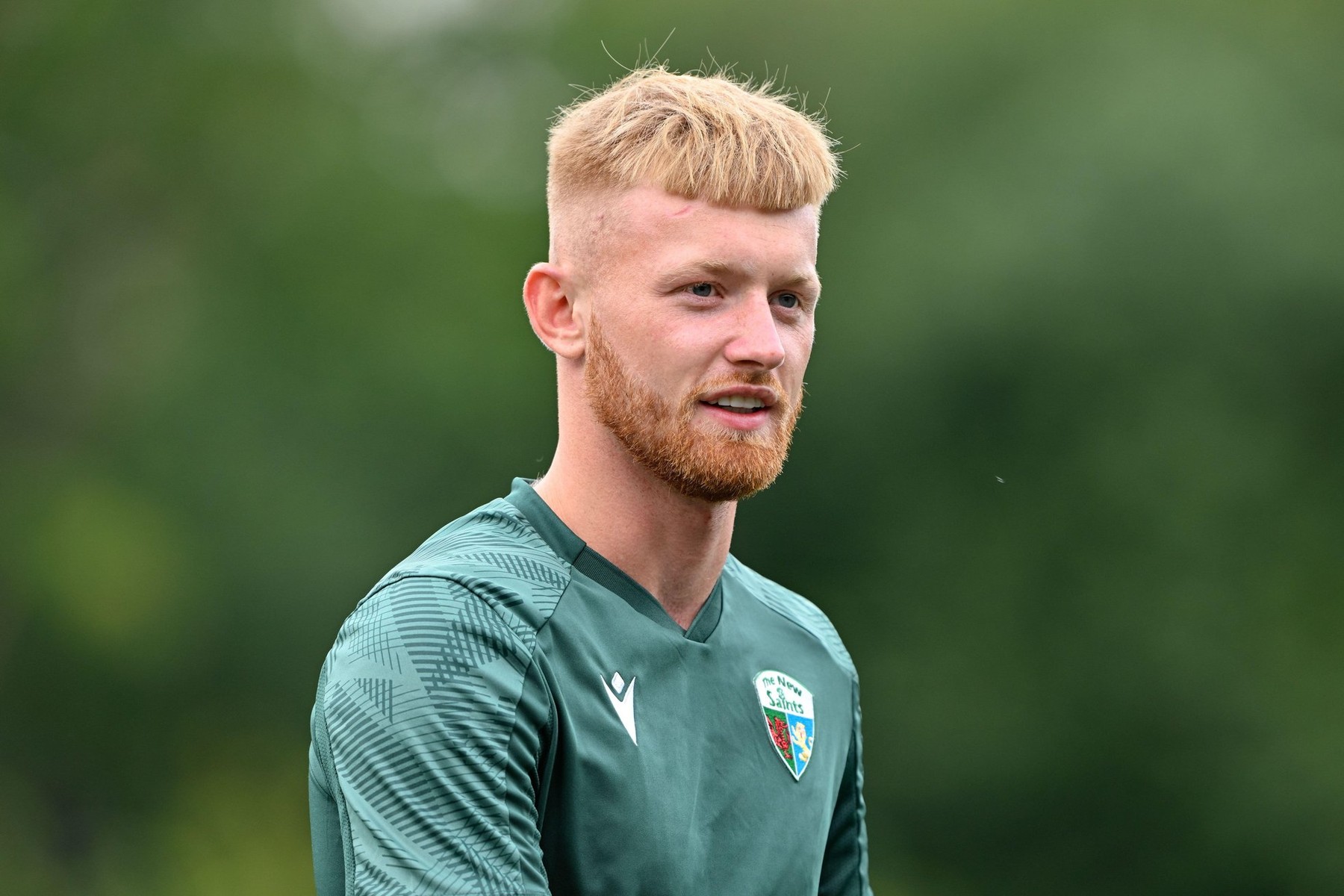 Brad Young of The New Saints all smiles as he inspects the pitch ahead of the UEFA Champions League Second Qualifying Round match The New Saints vs Ferencvros at Park Hall Stadium, Oswestry, United Kingdom, 30th July 2024(Photo by Cody Froggatt/News Ima