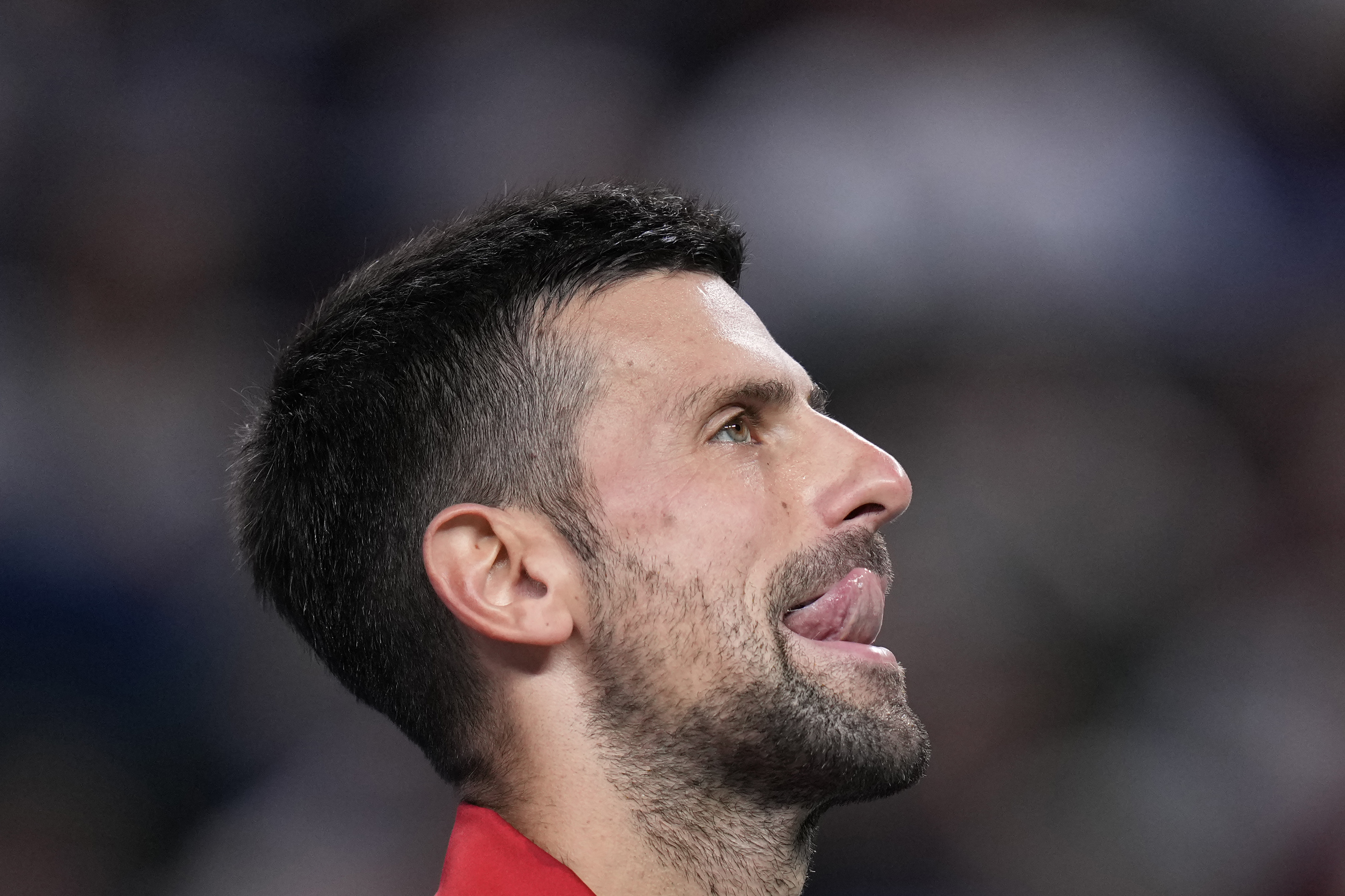 Novak Djokovic of Serbia reacts during the men's singles finals match against Jannik Sinner of Italy in the Shanghai Masters tennis tournament at Qizhong Forest Sports City Tennis Center in Shanghai, China, Sunday, Oct. 13, 2024. (AP Photo/Andy Wong)